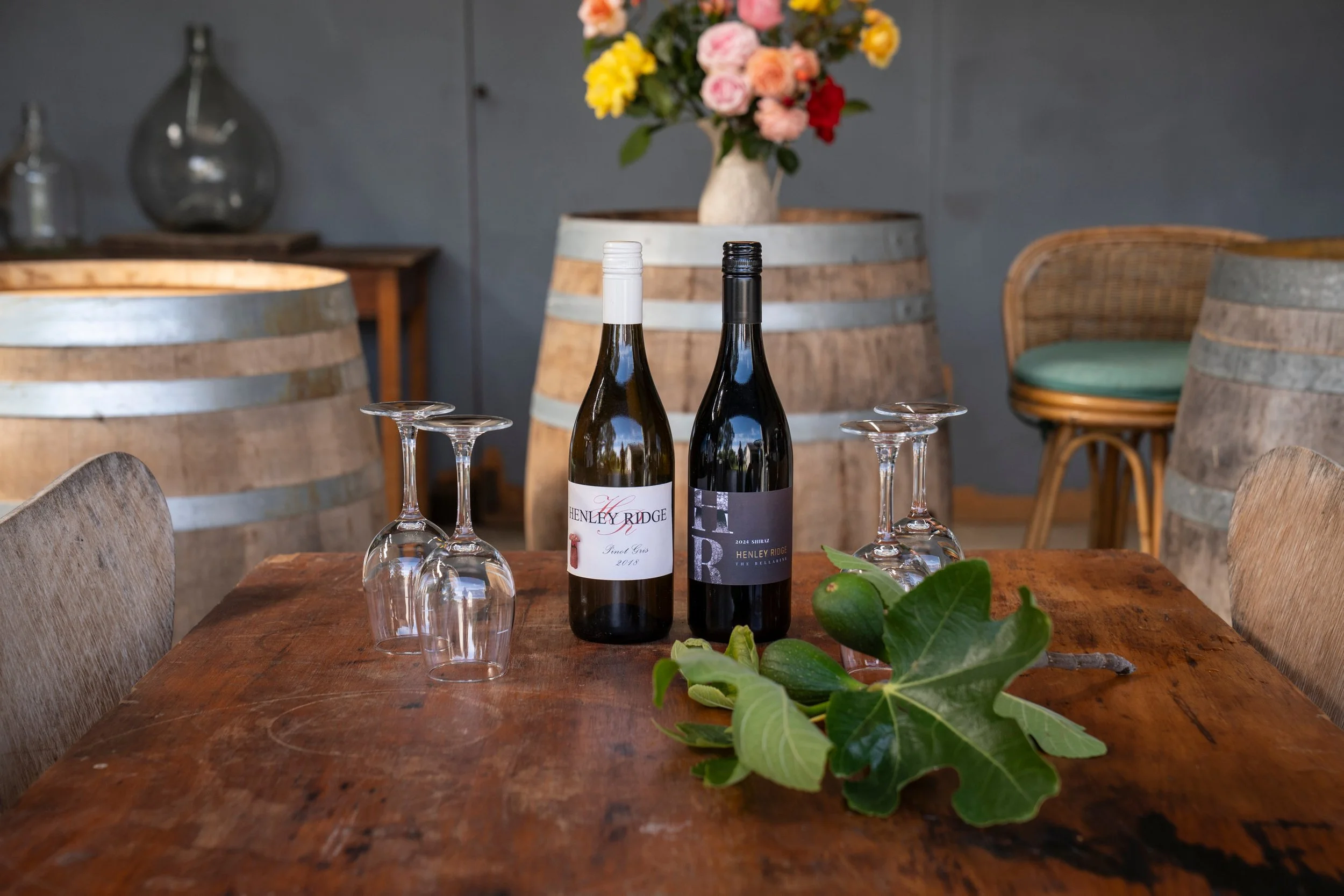 Red and white wine bottles on a table at Henley Ridge Wines Micro vineyard Bellarine.