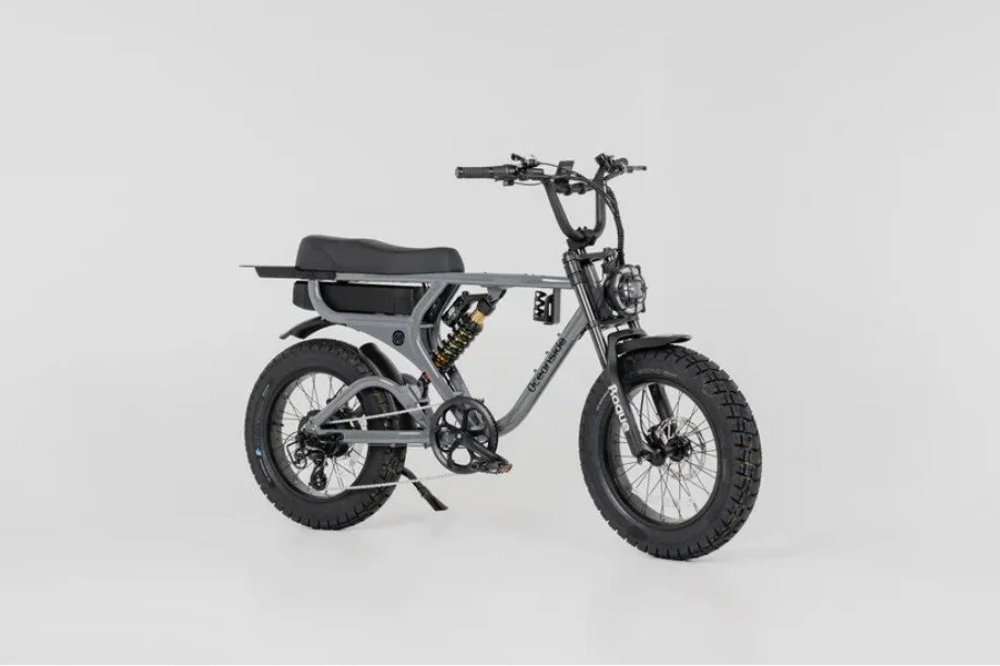 Electric fat tire bike with a black seat and handlebar, gray frame, and chunky tires against a plain white background.