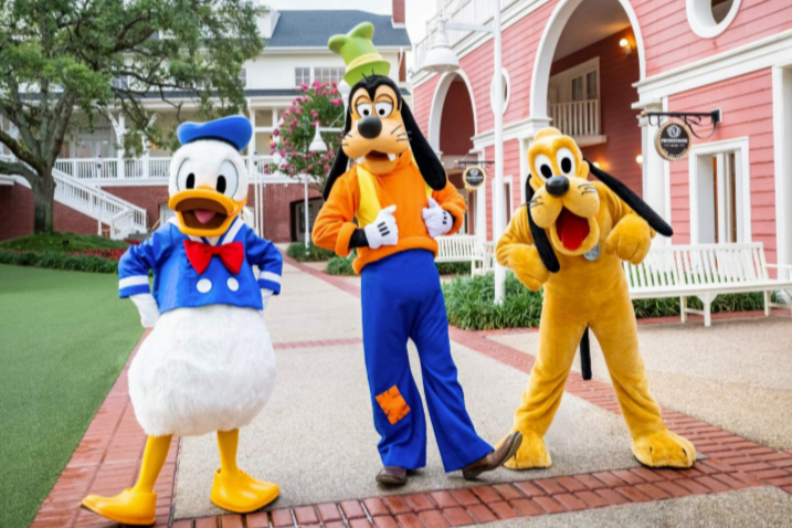 Disney vacation planning featuring Donald Duck Goofy and Pluto at Walt Disney World by Ruggles & Routes Travel Co