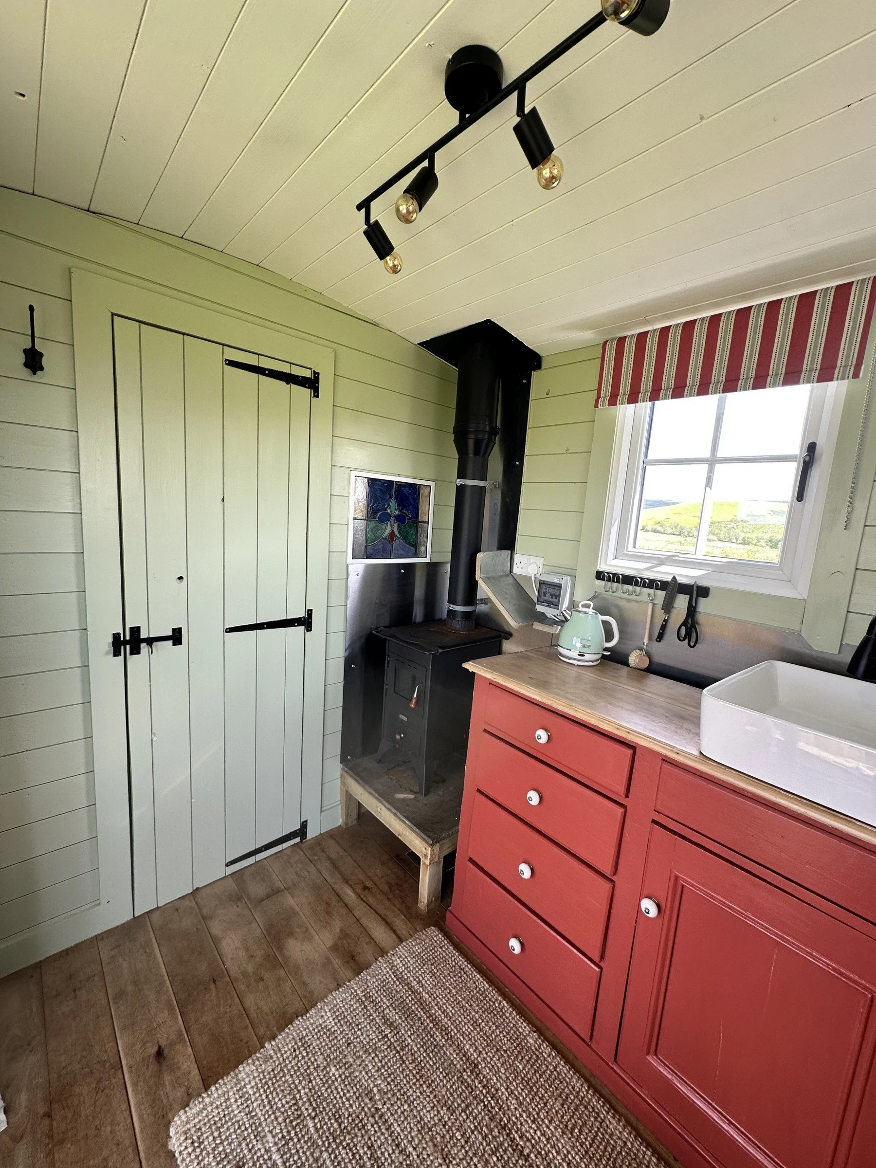 A compact kitchen and wood-burning stove for cosy evenings.