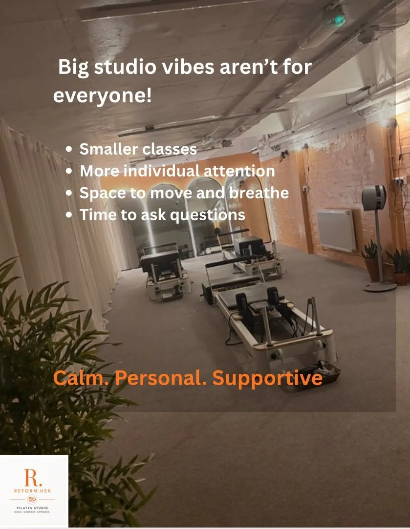 A Pilates studio with reformer machines arranged in a row, beige curtains on one side, and an exposed brick wall with heating radiator. The ceiling has an industrial look with low lighting. The image contains overlay text promoting small classes, individual attention, space to breathe, and questions, with the phrase "Calm. Personal. Supportive" in orange at the bottom.