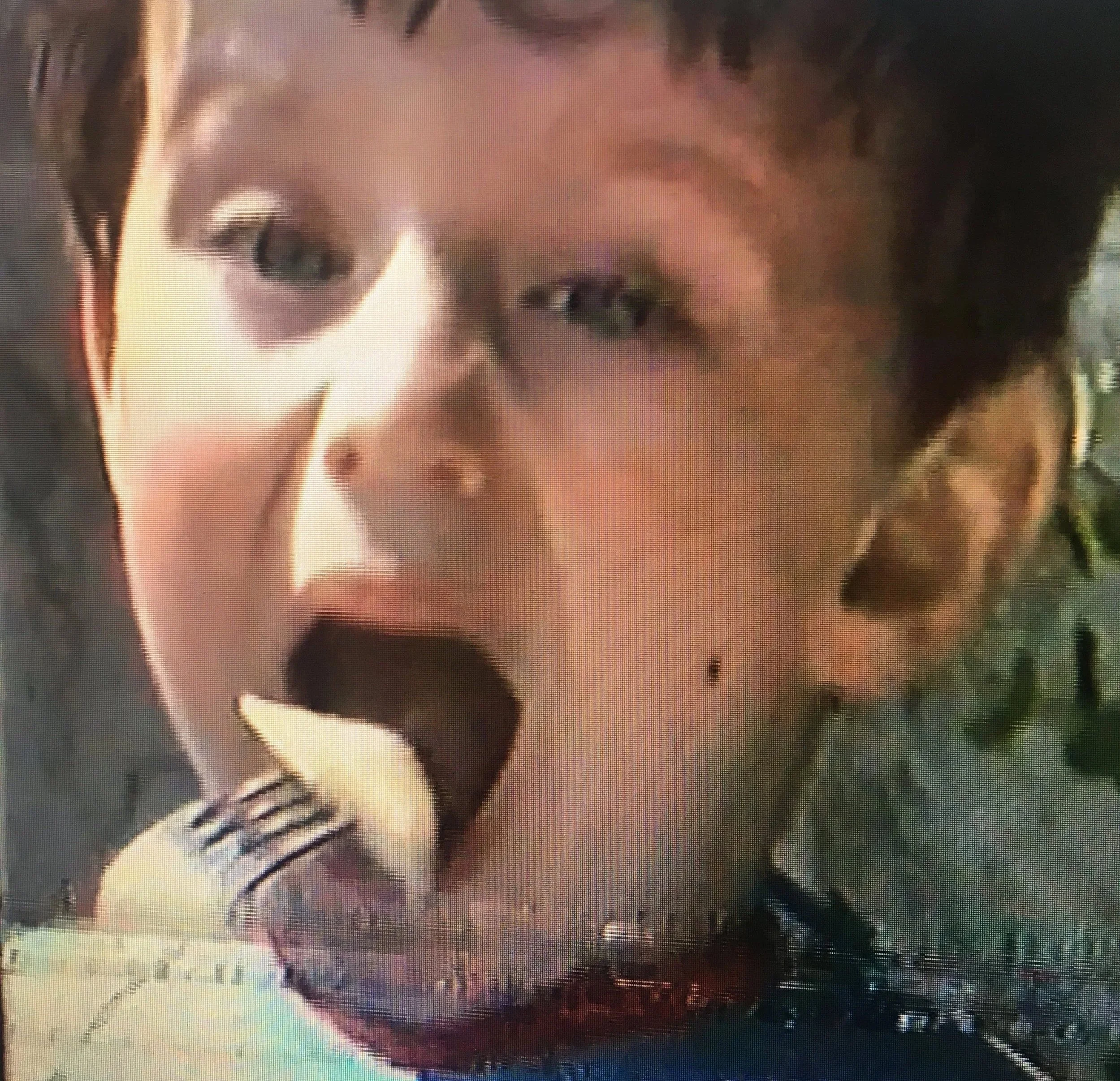 Félix Martinaud as a young boy with short dark hair singing into a microphone.