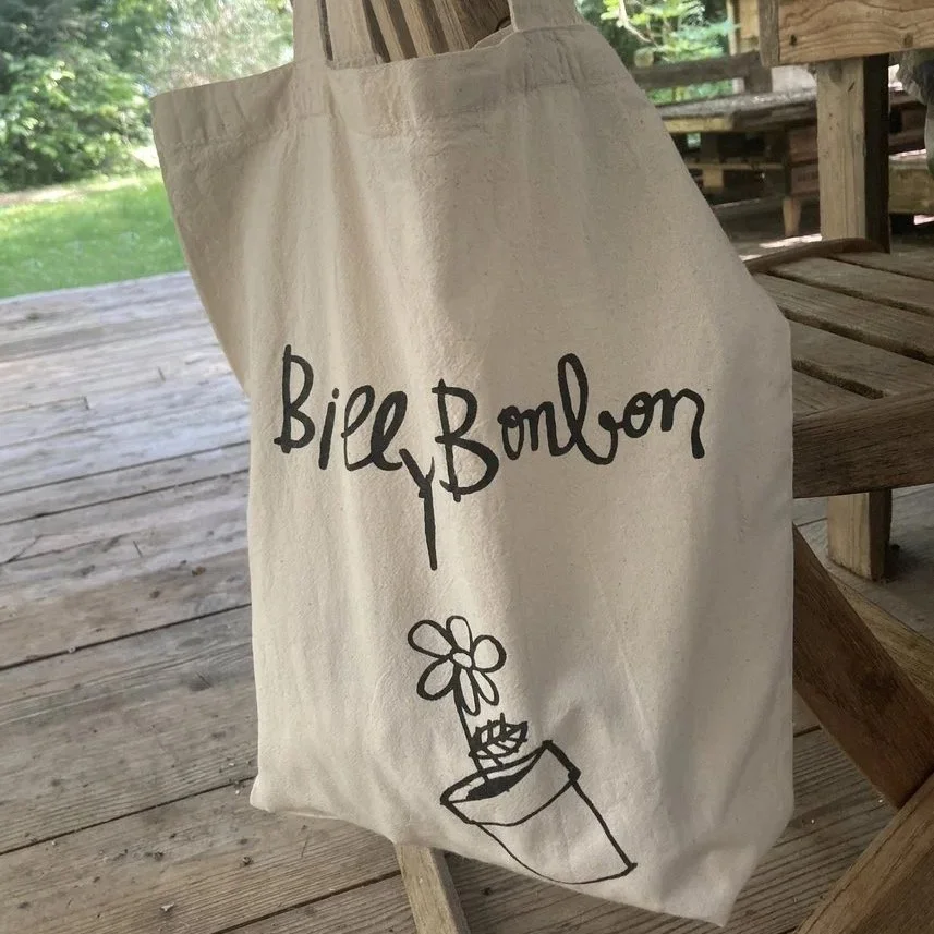 Canvas bag with the name 'Bill Bombon' and a drawing of a potted plant with a flower on top.
