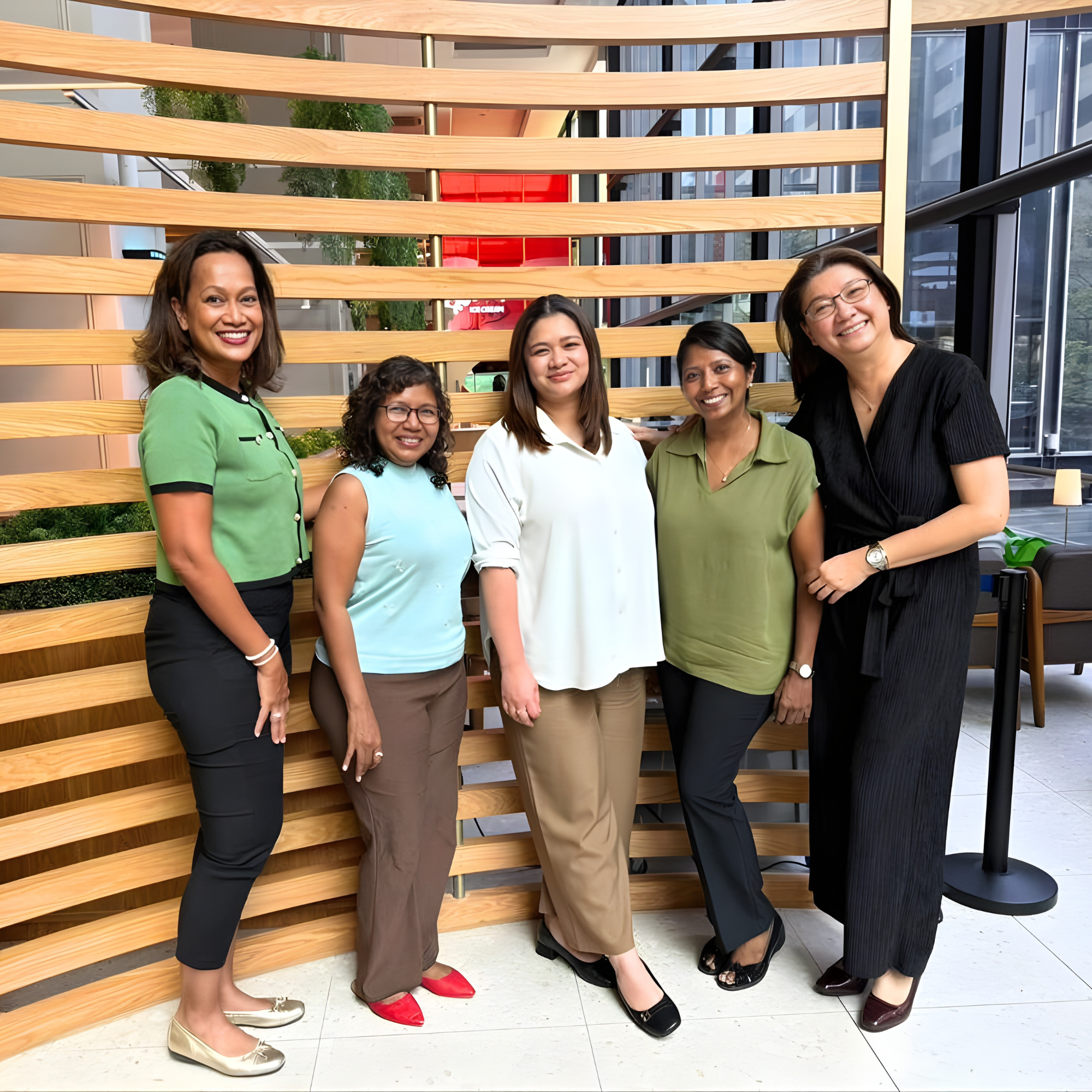 WIPR Founding members standing together indoors in front of a wooden wall, smiling at the camera.