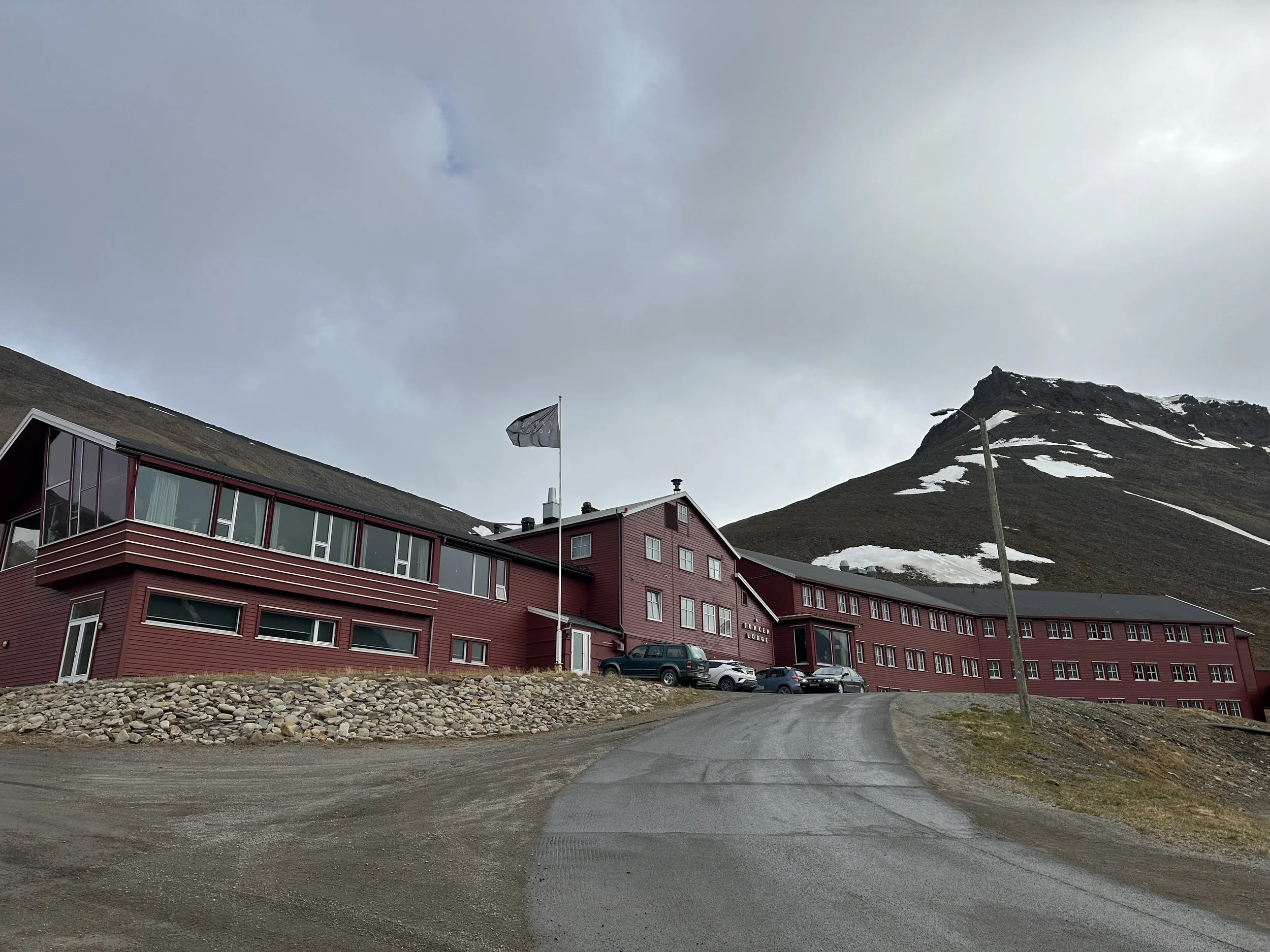 Funken lodge in Longyearbyen, a classic red wooden hotel surrounded by mountains and tundra on Svalbard.