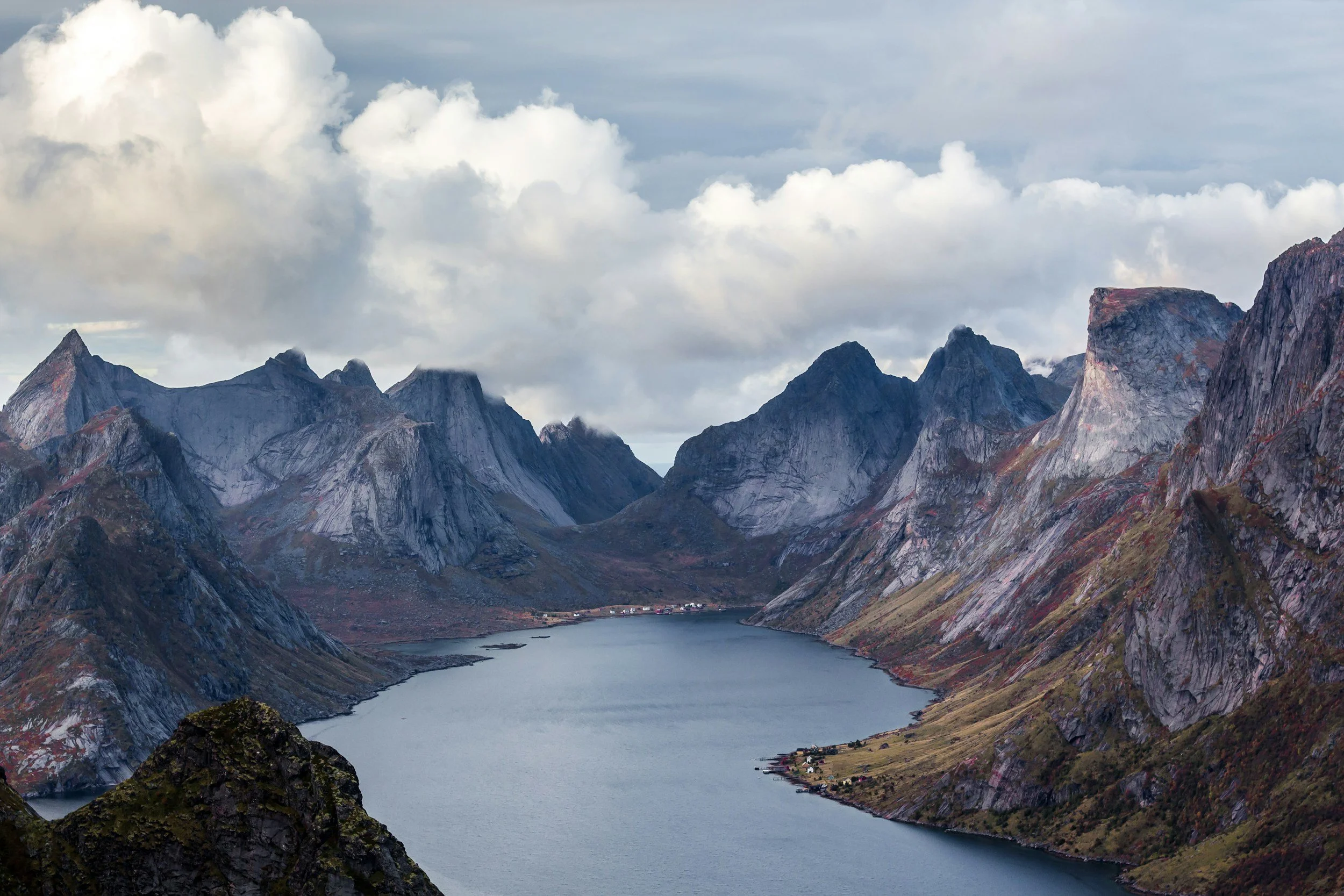Dramatic Lofoten Islands landscape with steep mountains blue fjord and rugged coastline showcasing some of the most impressive scenery in Norway