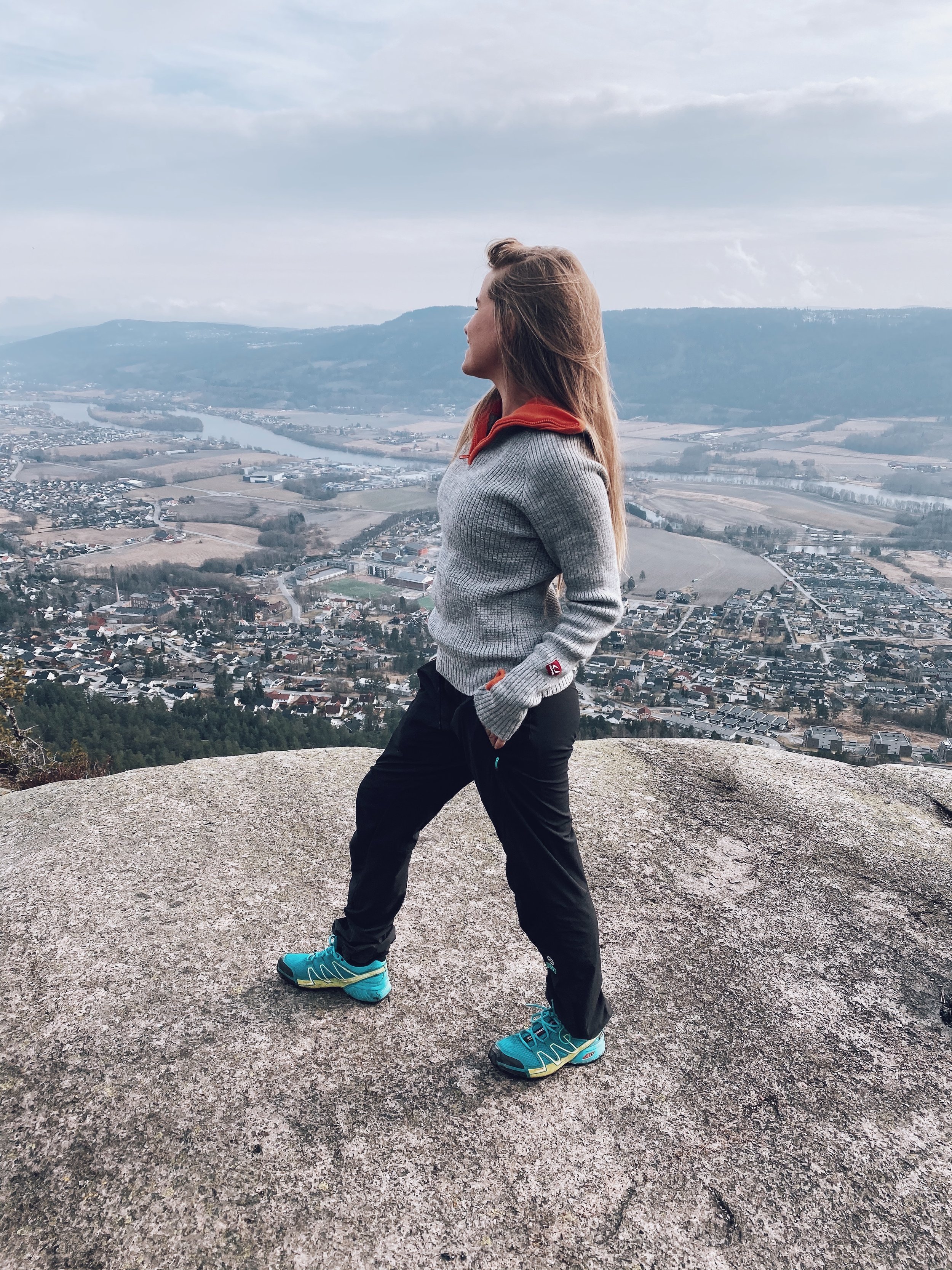 Wearing layered clothing on an exposed mountain viewpoint in Norway.