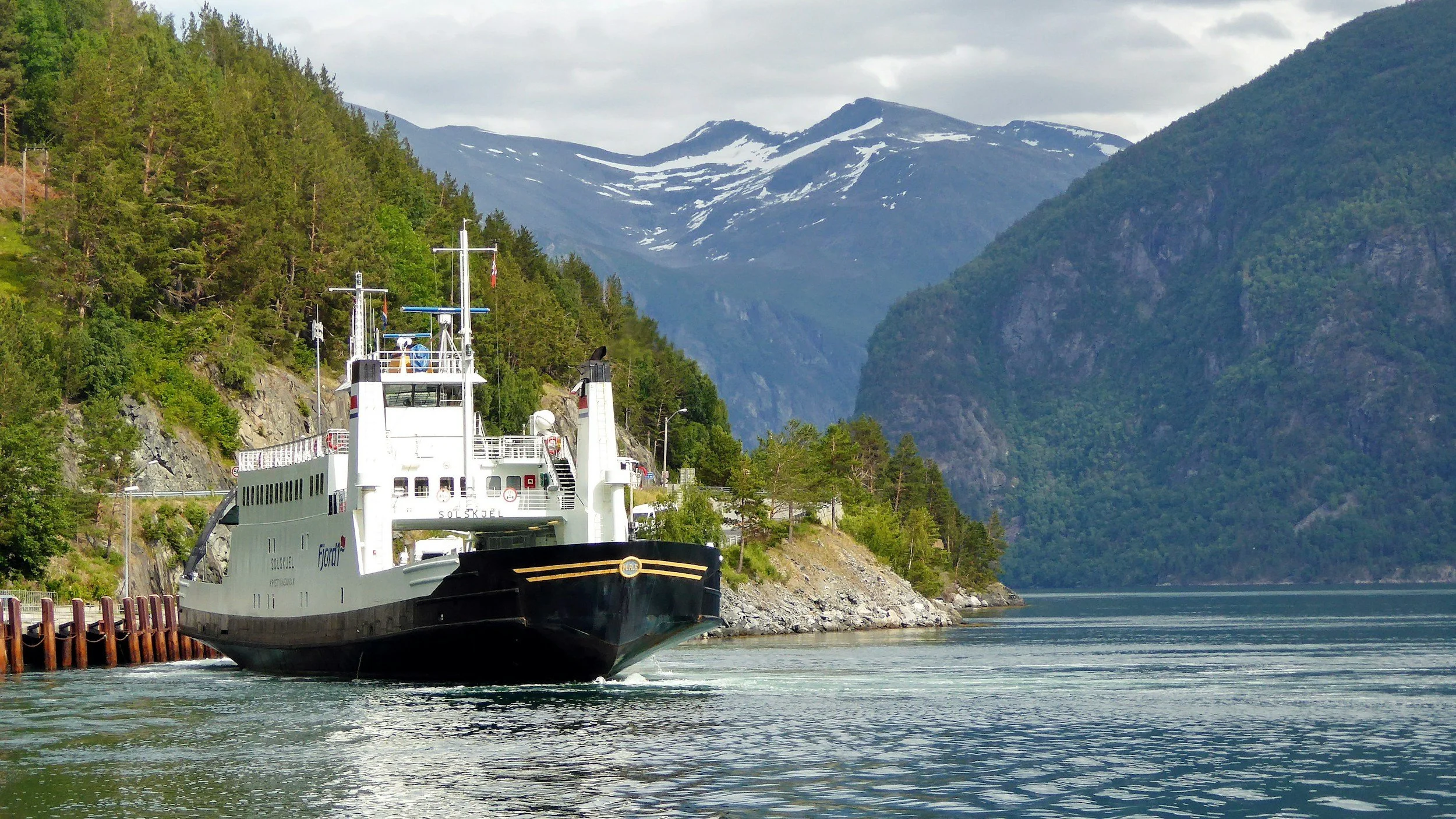 Car ferry operating on a Norwegian fjord, illustrating how ferry crossings function as part of the national road network.