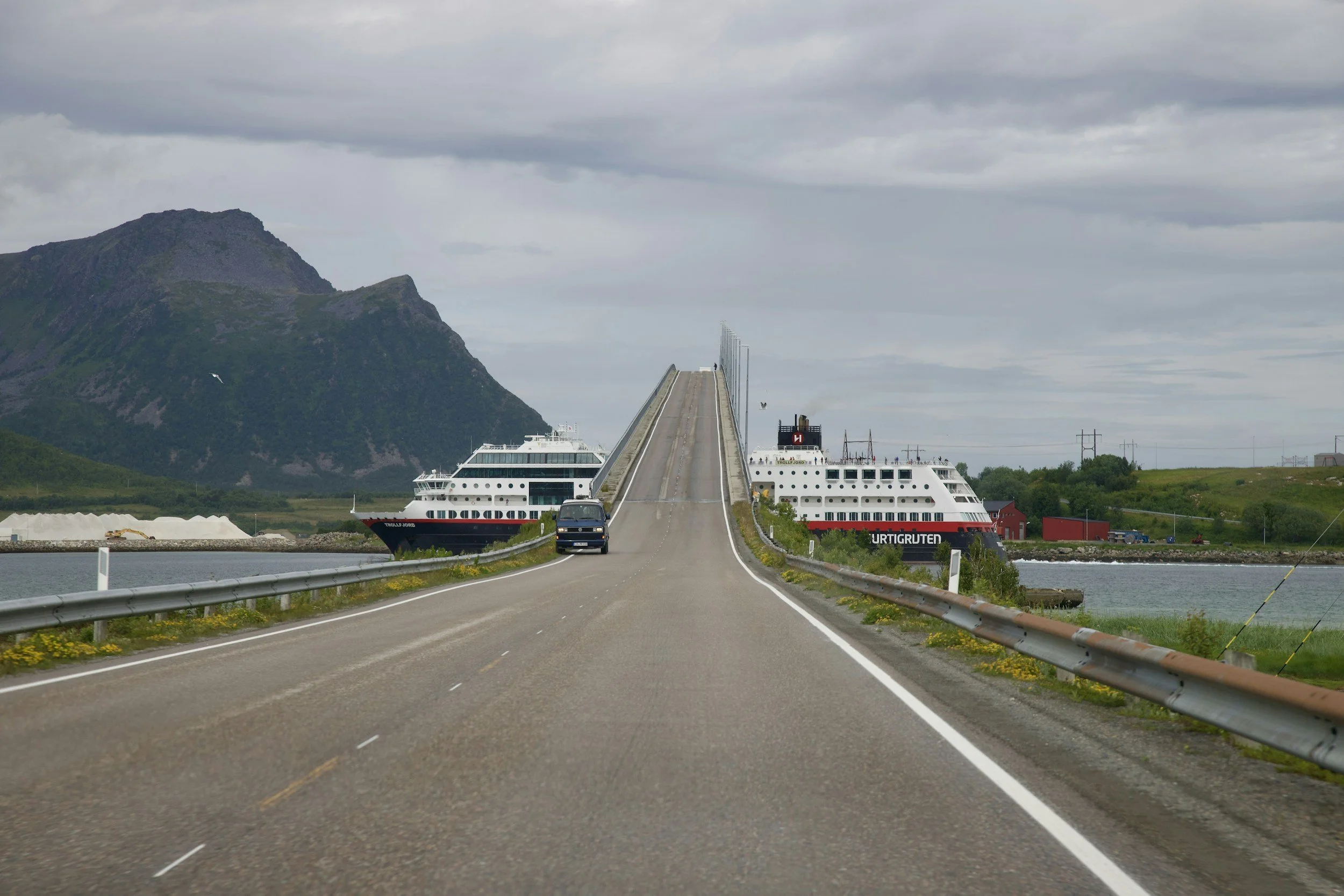 A ferry crossing under a bridge in Norway.