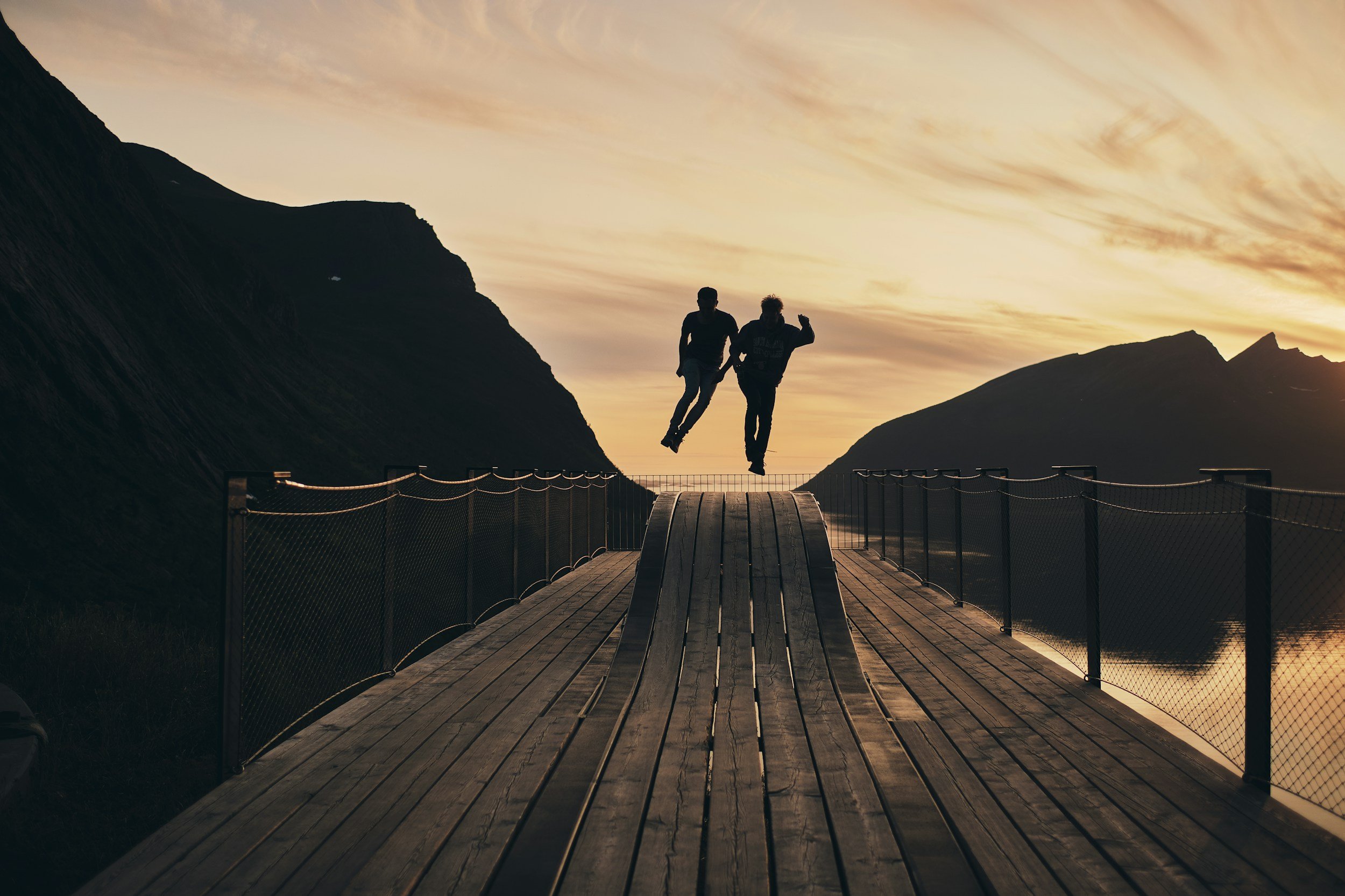 people jumping in front of a viewpoint in Senja.