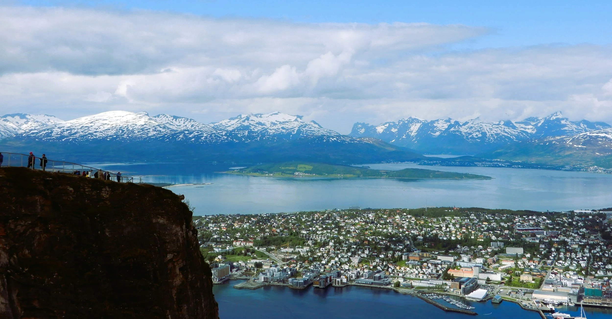 Tromsø city in summer, with snow capped mountains.