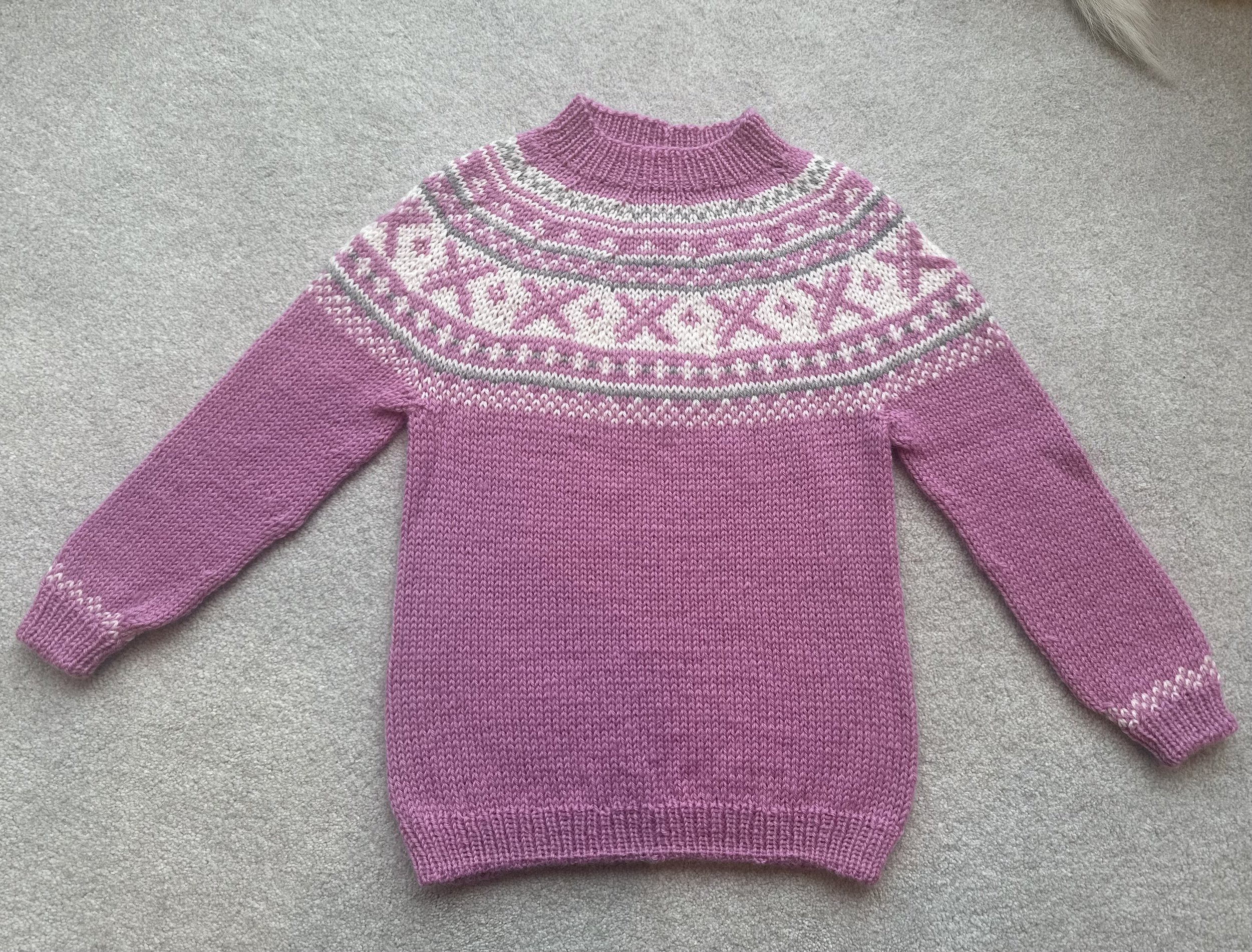 Hand-knitted Norwegian wool sweater with traditional pattern, suitable for cold-weather layering.