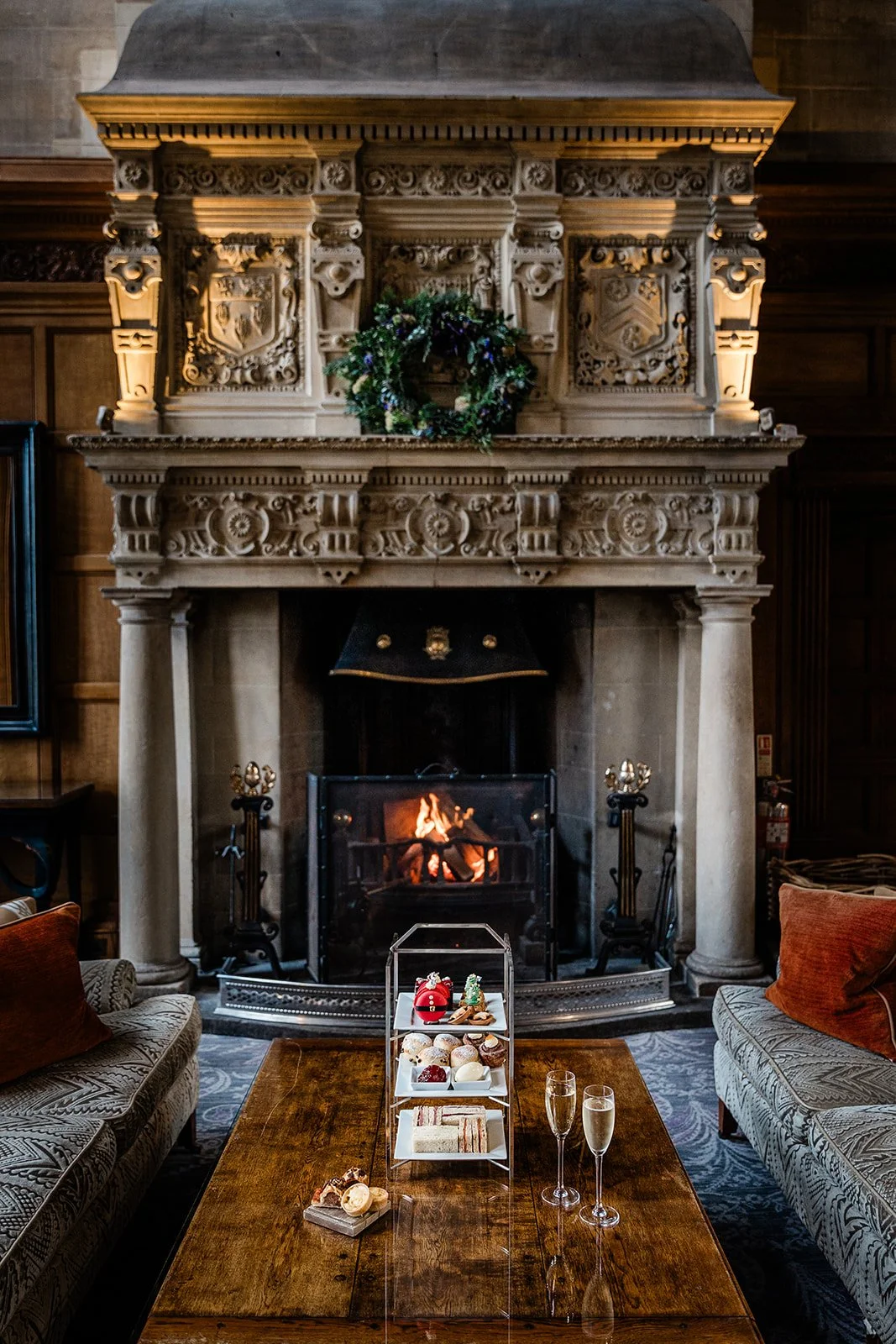 Christmas afternoon tea at Bovey Castle served in a lounge room by a large stone fireplace.