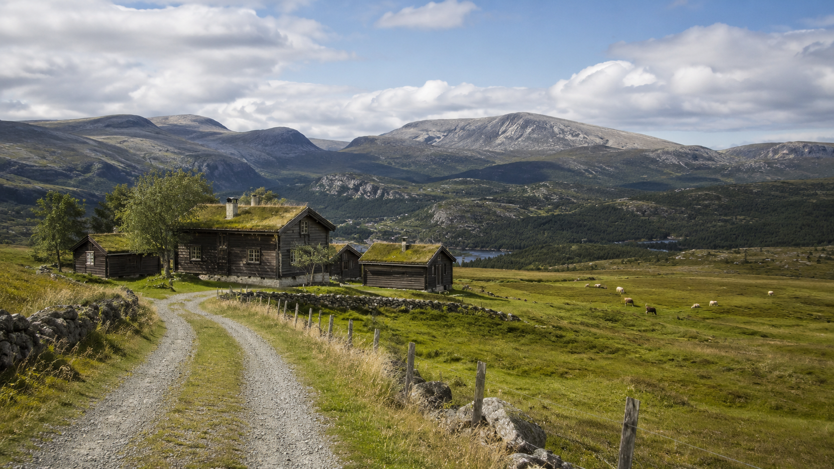 A beautiful norwegian støl and cabin in front of the beautiful mountains of Valdres in Norway.