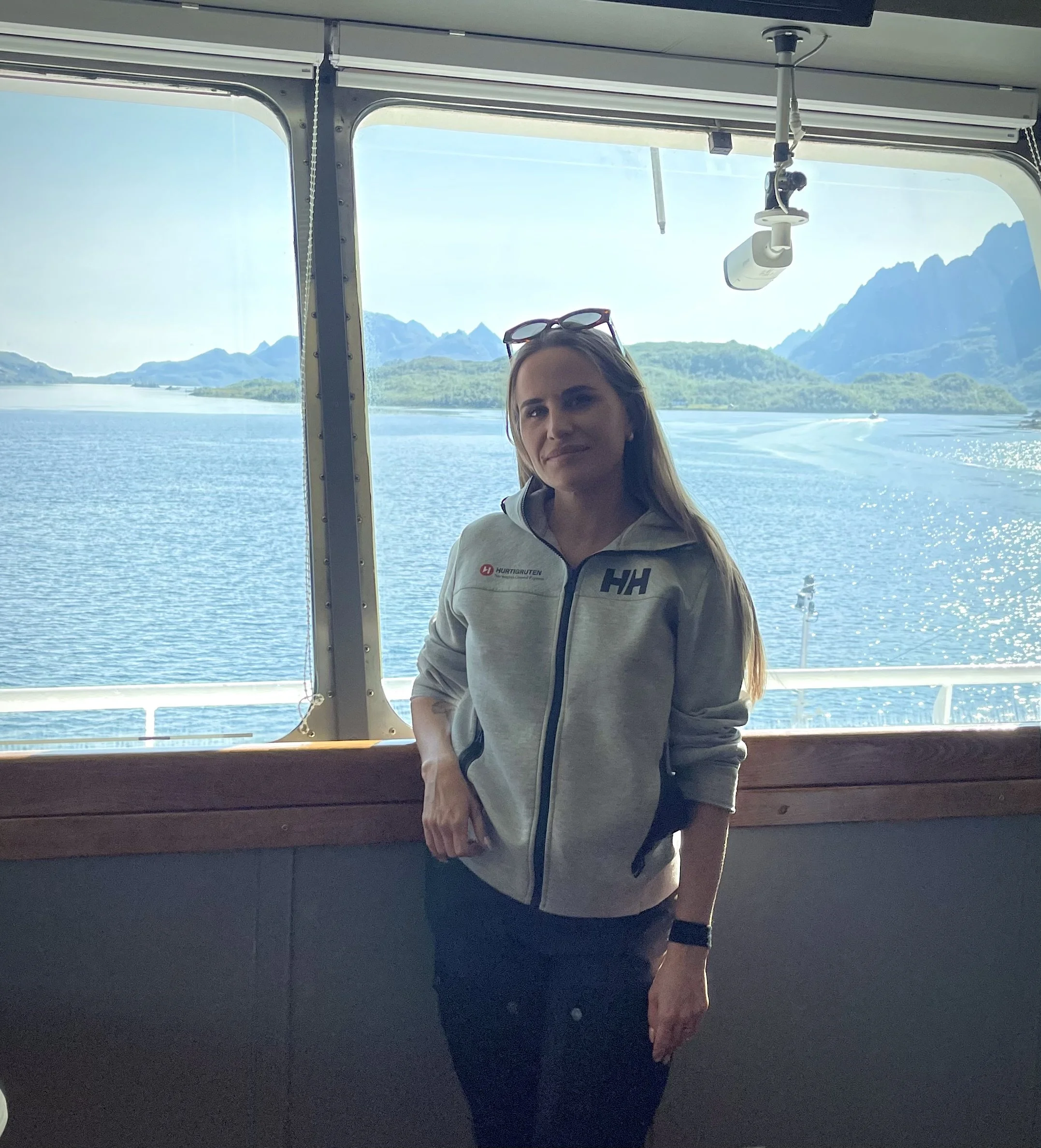 Relaxed onboard clothing on a Norwegian coastal cruise, featuring a lightweight technical jacket and a motion sickness wristband.