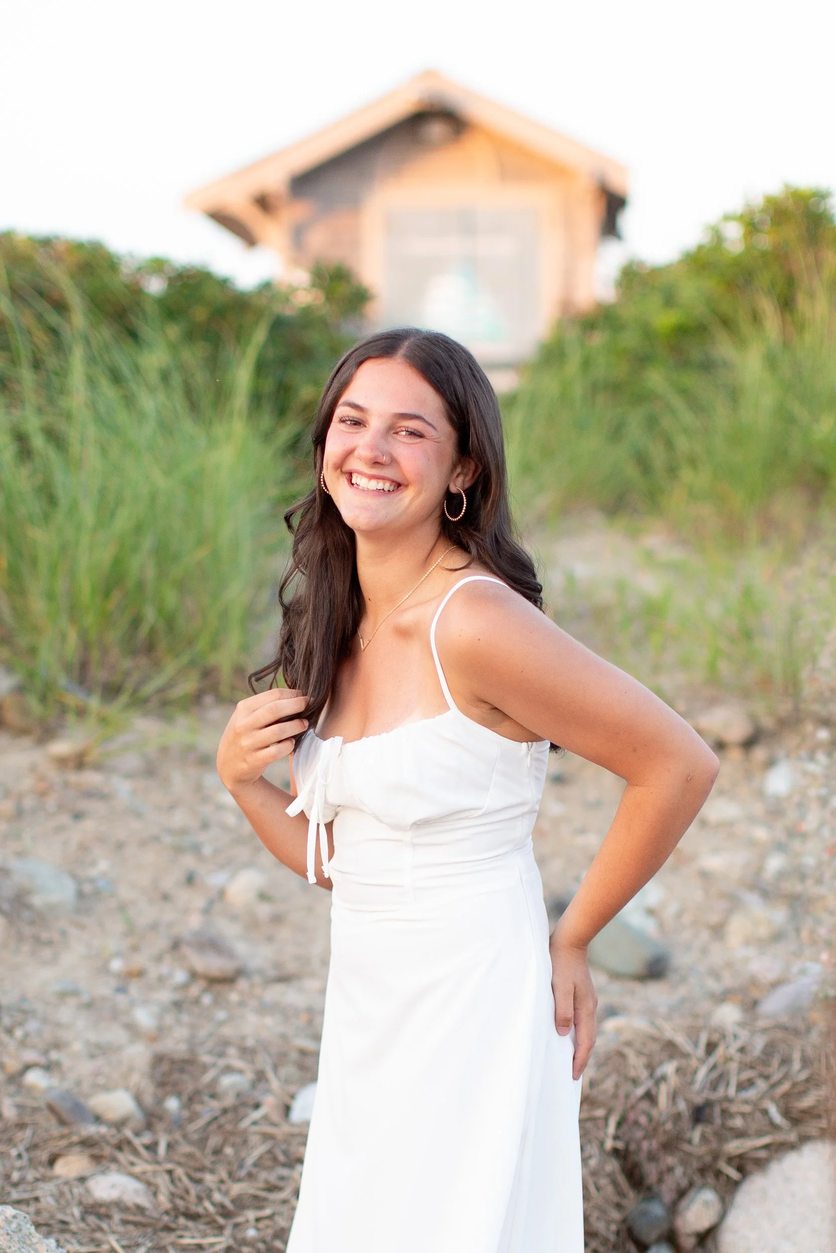 Candid senior portrait of an Oliver Ames High School senior laughing during her beach session.