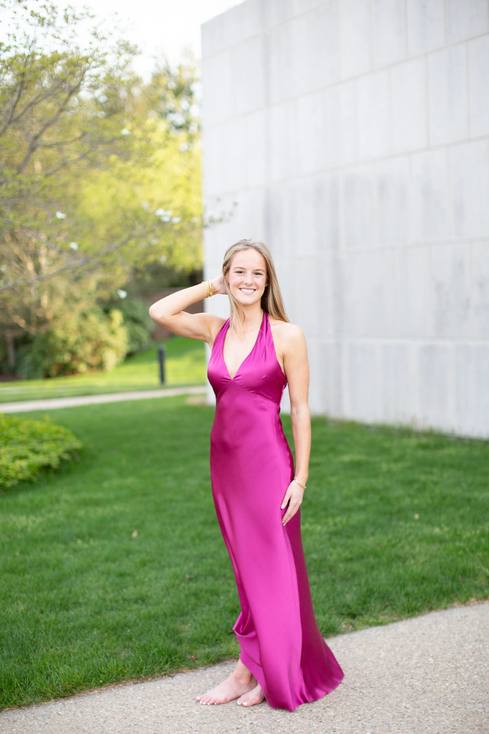 Mansfield MA college graduate posing in satin dress at Bryant University