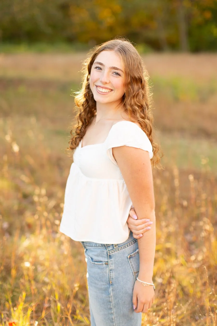 Senior girl smiling during fall portrait session in Walpole MA by Courtney Wager Photography
