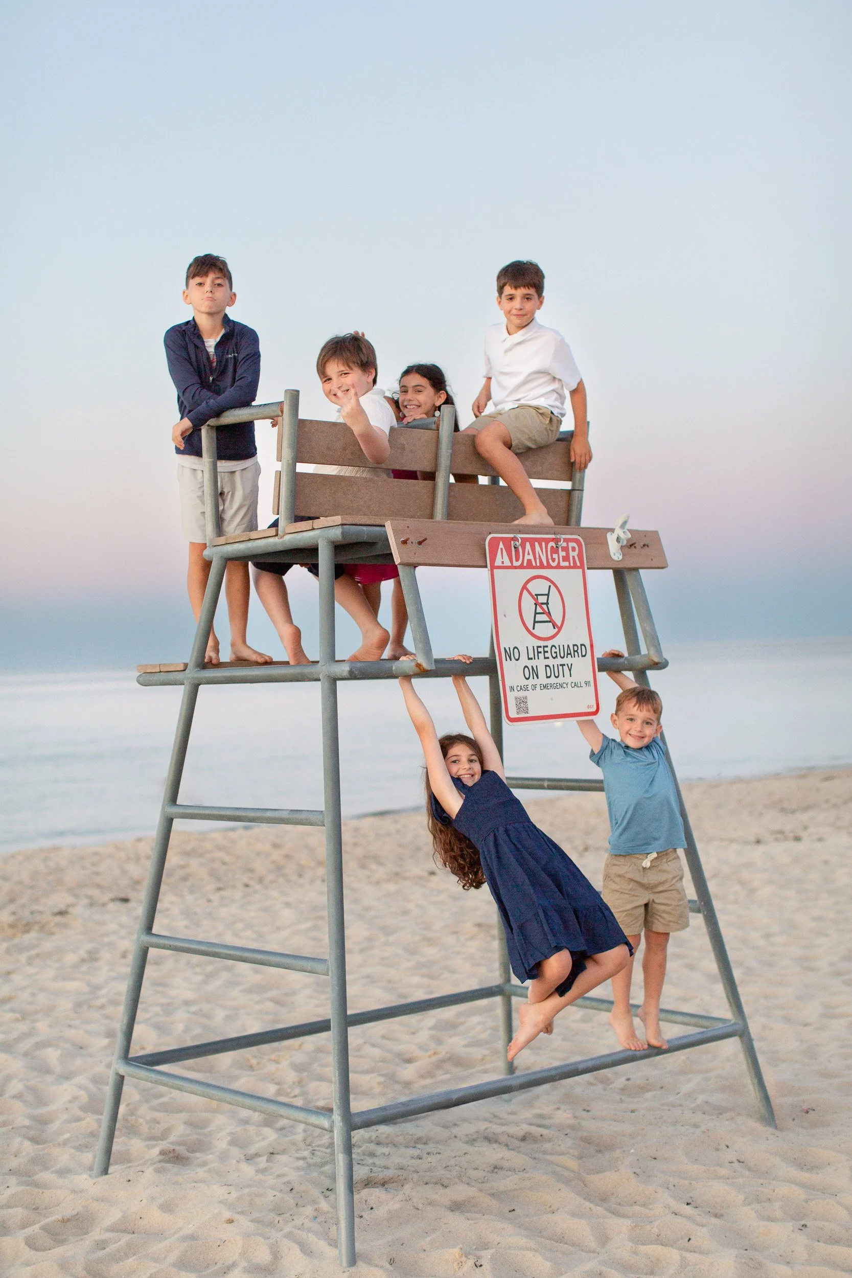 Family enjoying an unposed moment together during their Cape Cod beach session.