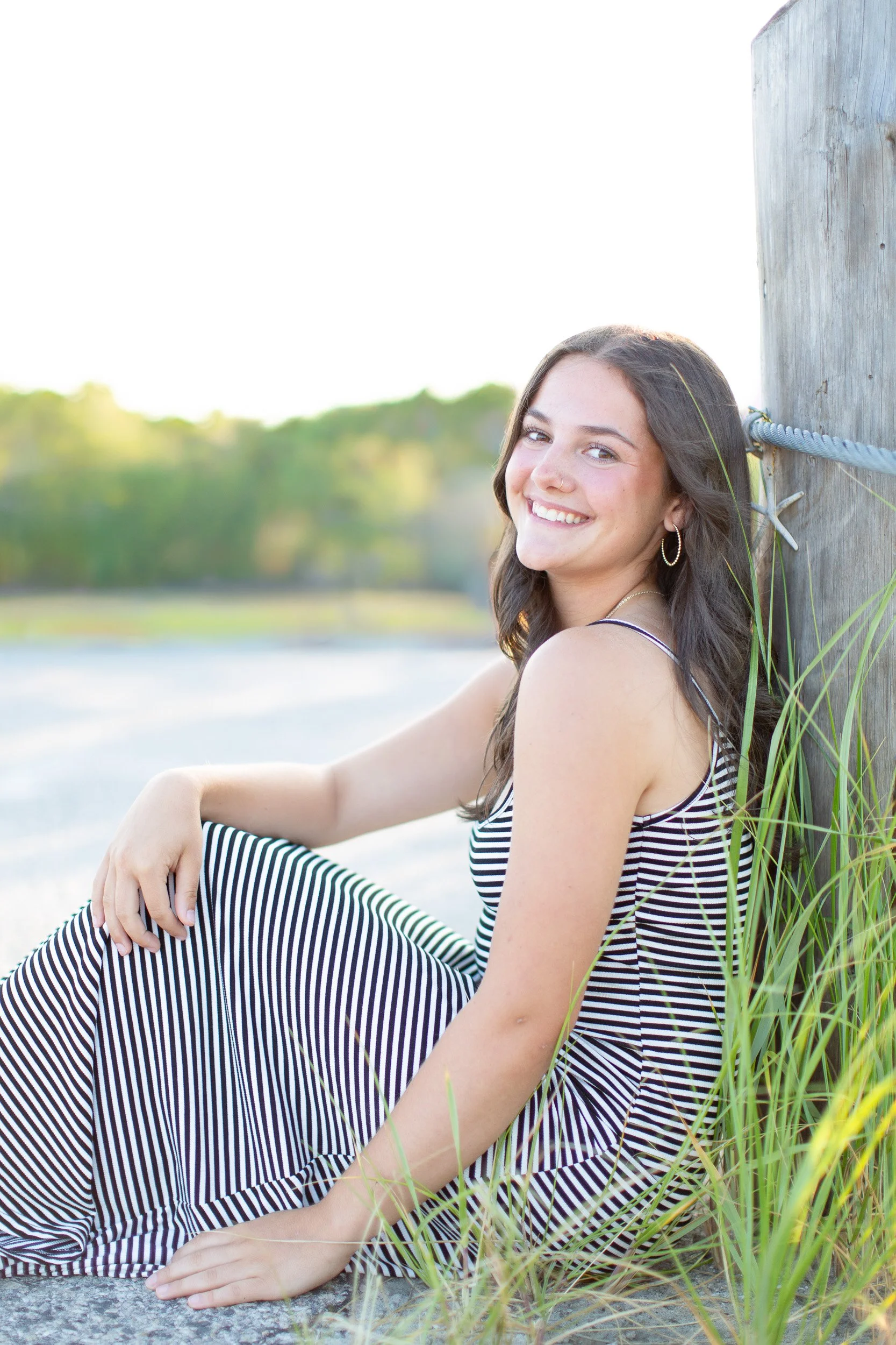 Easton, MA senior Logan smiling during her senior photo session at Duxbury Beach.