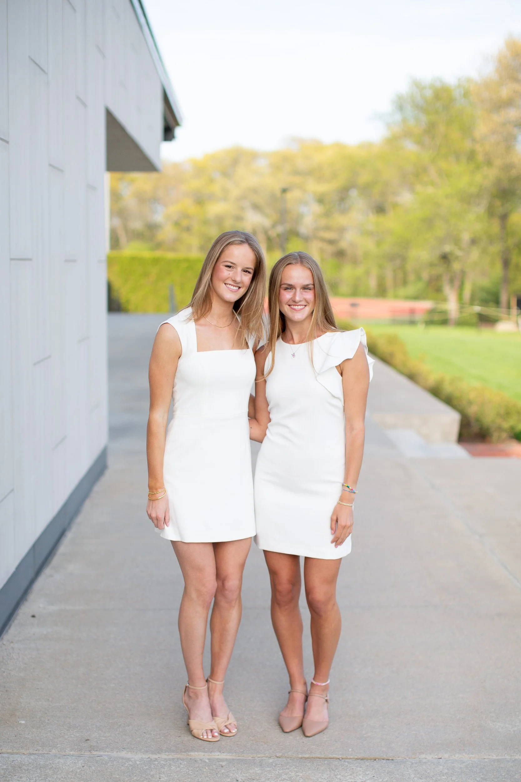Mansfield MA college graduate posing in white dress at Bryant University