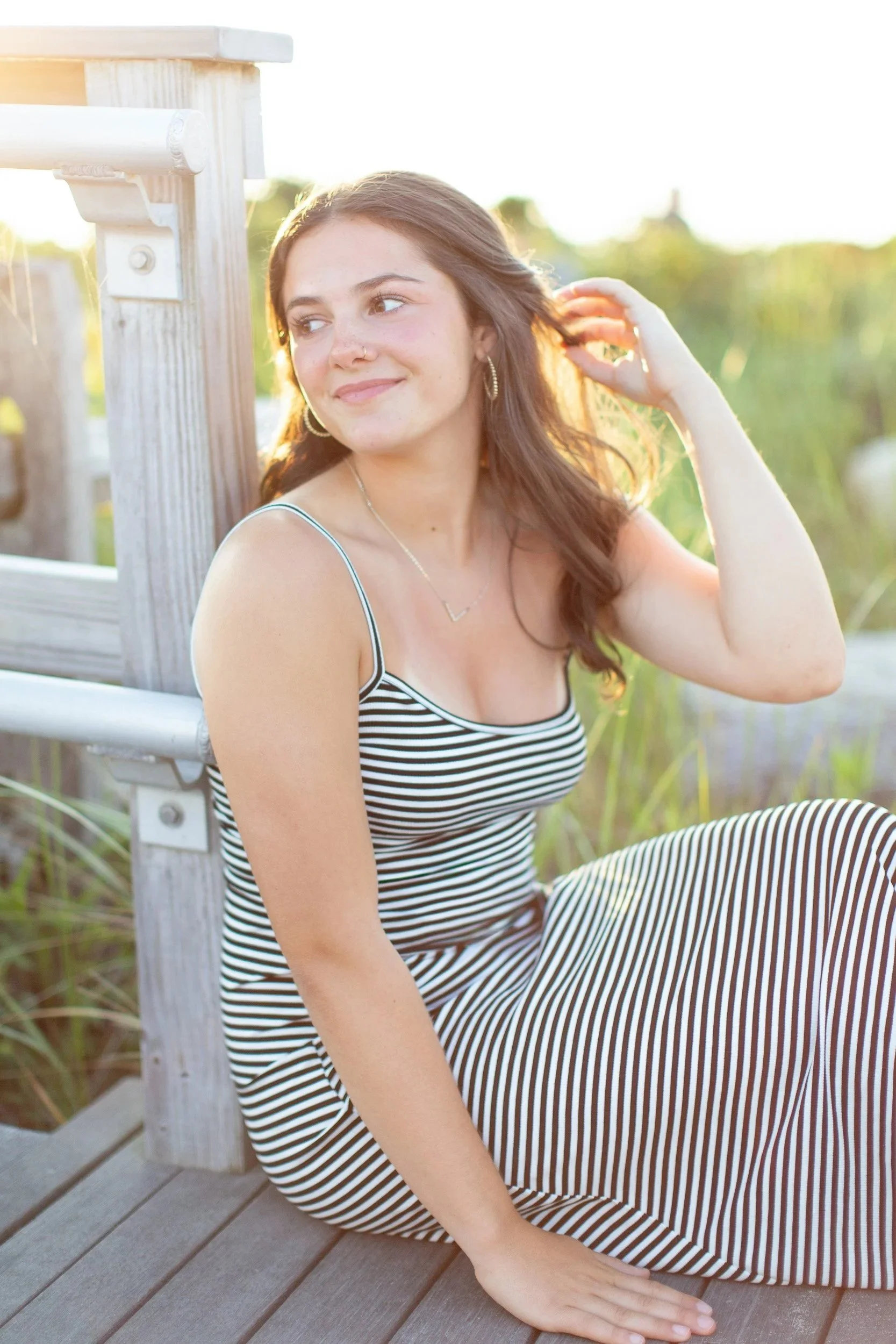 Oliver Ames High School senior portrait of Logan at Duxbury Beach during golden hour.
