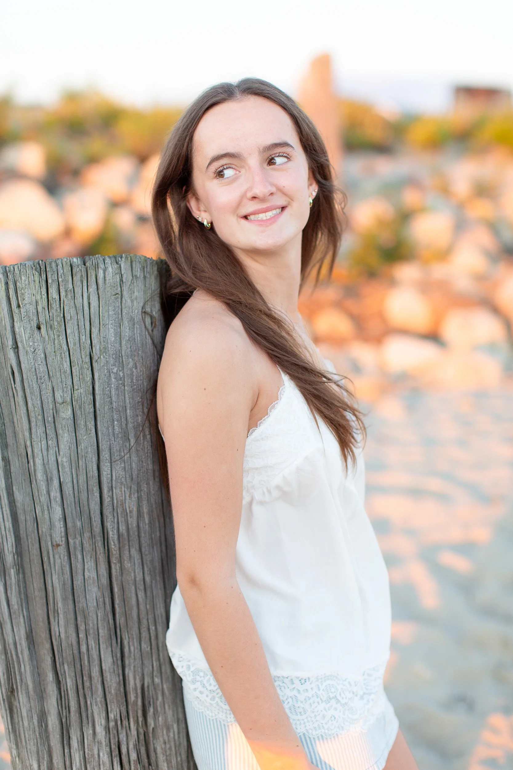 High school senior photographed in soft evening light at Duxbury Beach