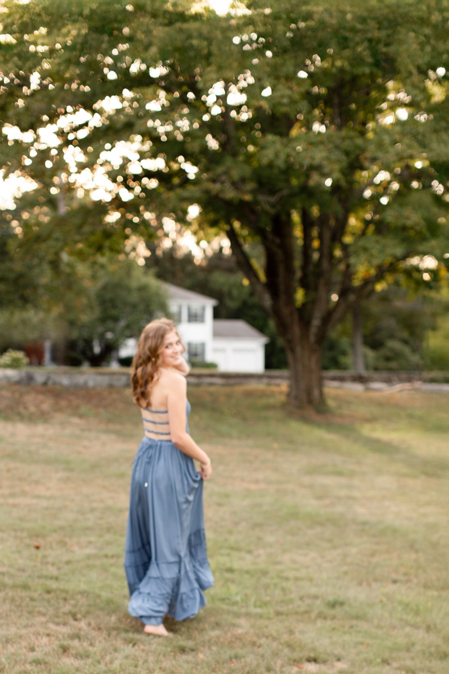 High school senior smiling naturally during a senior photos in Milton, Massachusetts