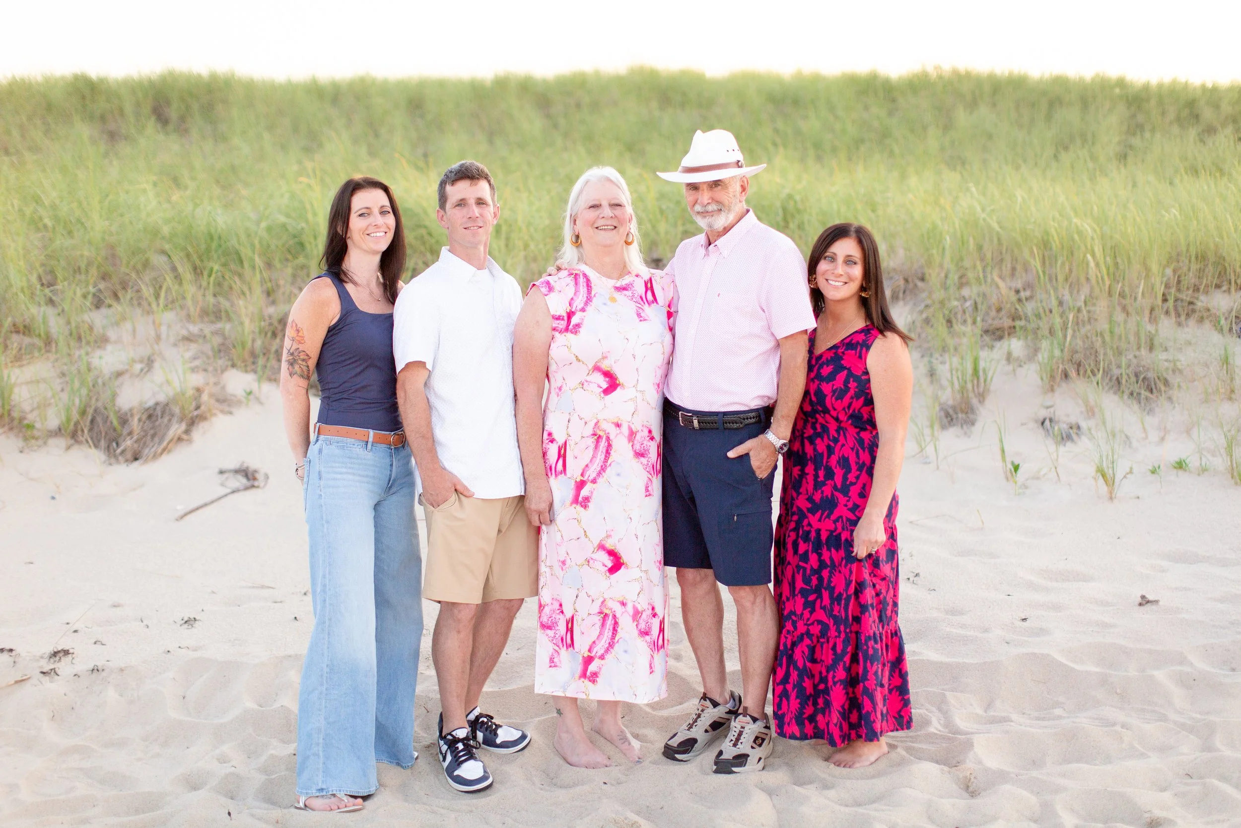 Grandparents posing with their adult children during an extended family photography session.