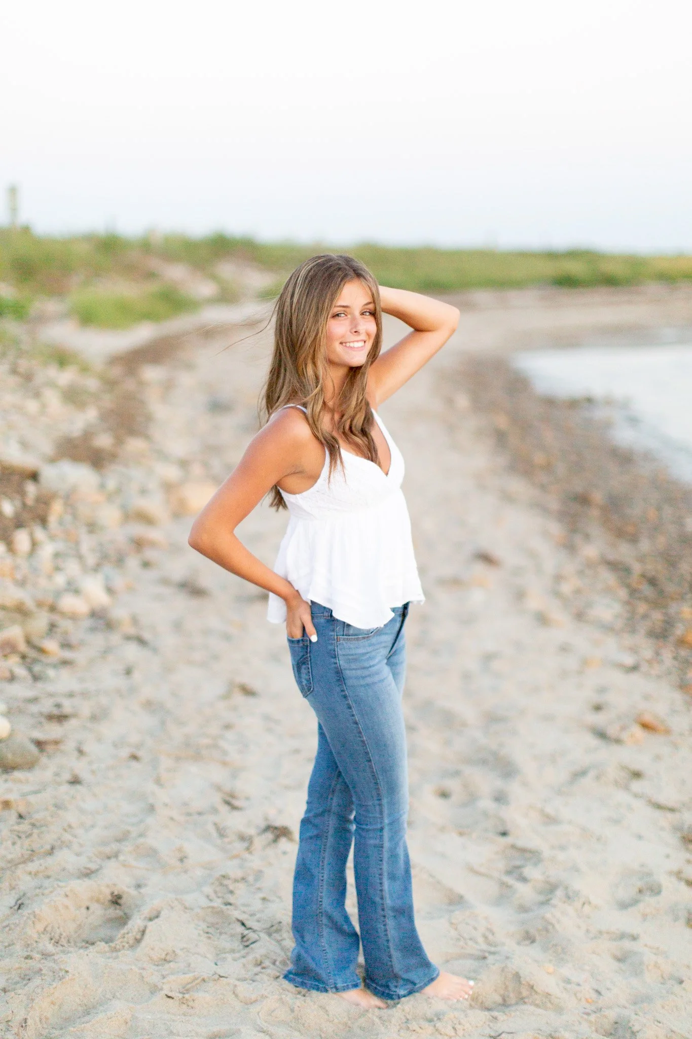 Full-length senior portrait of Lily at Duxbury Beach with a natural, effortless smile