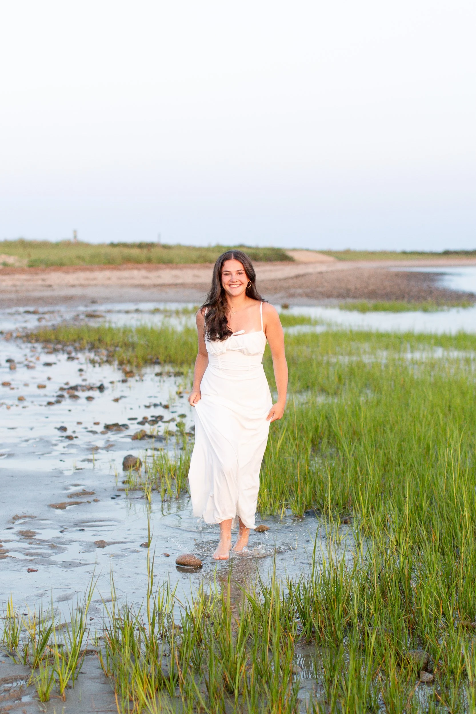 High school senior from Easton, Massachusetts walking along Duxbury Beach at sunset.