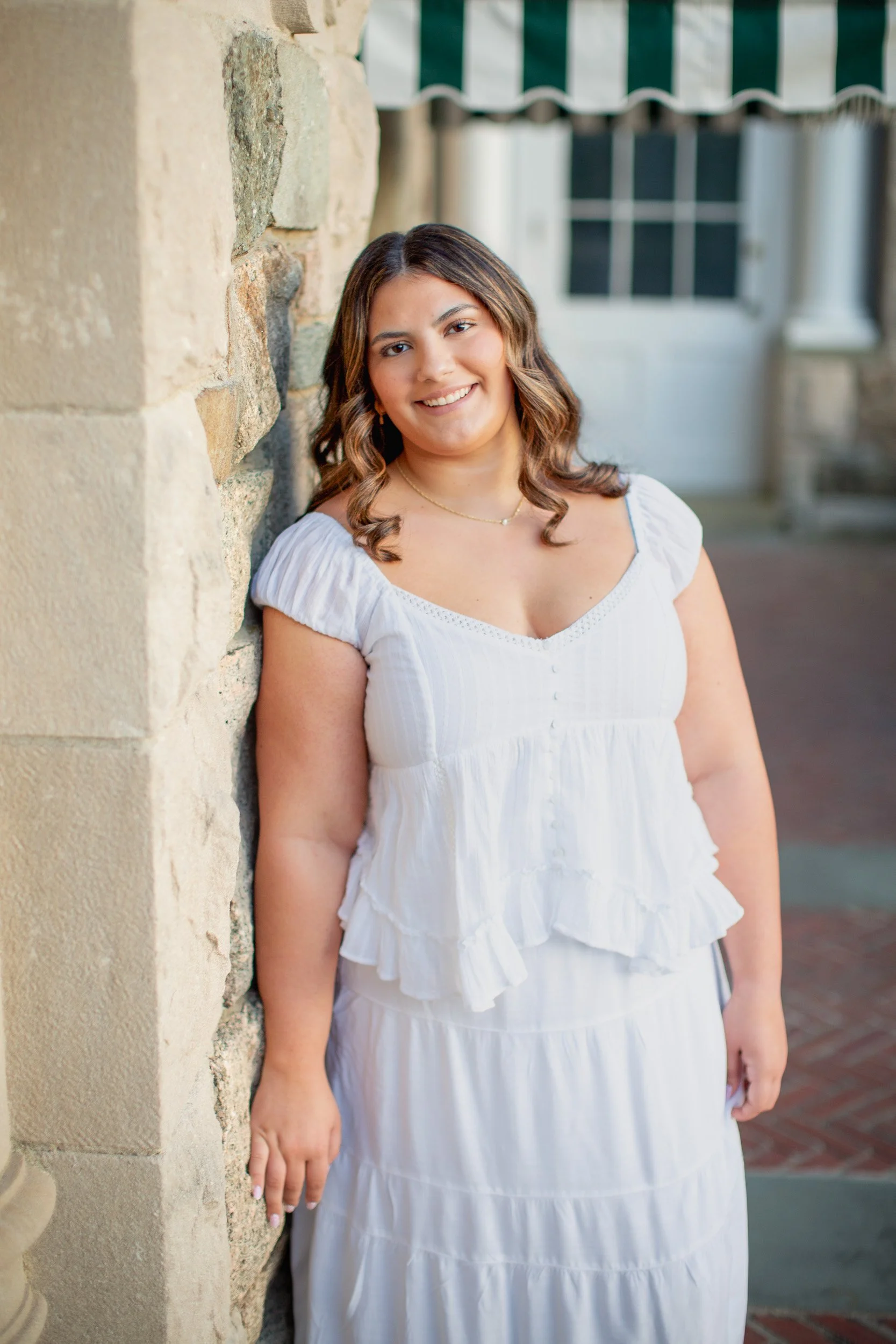 Senior photos beside the stone architecture at Blithewold Mansion