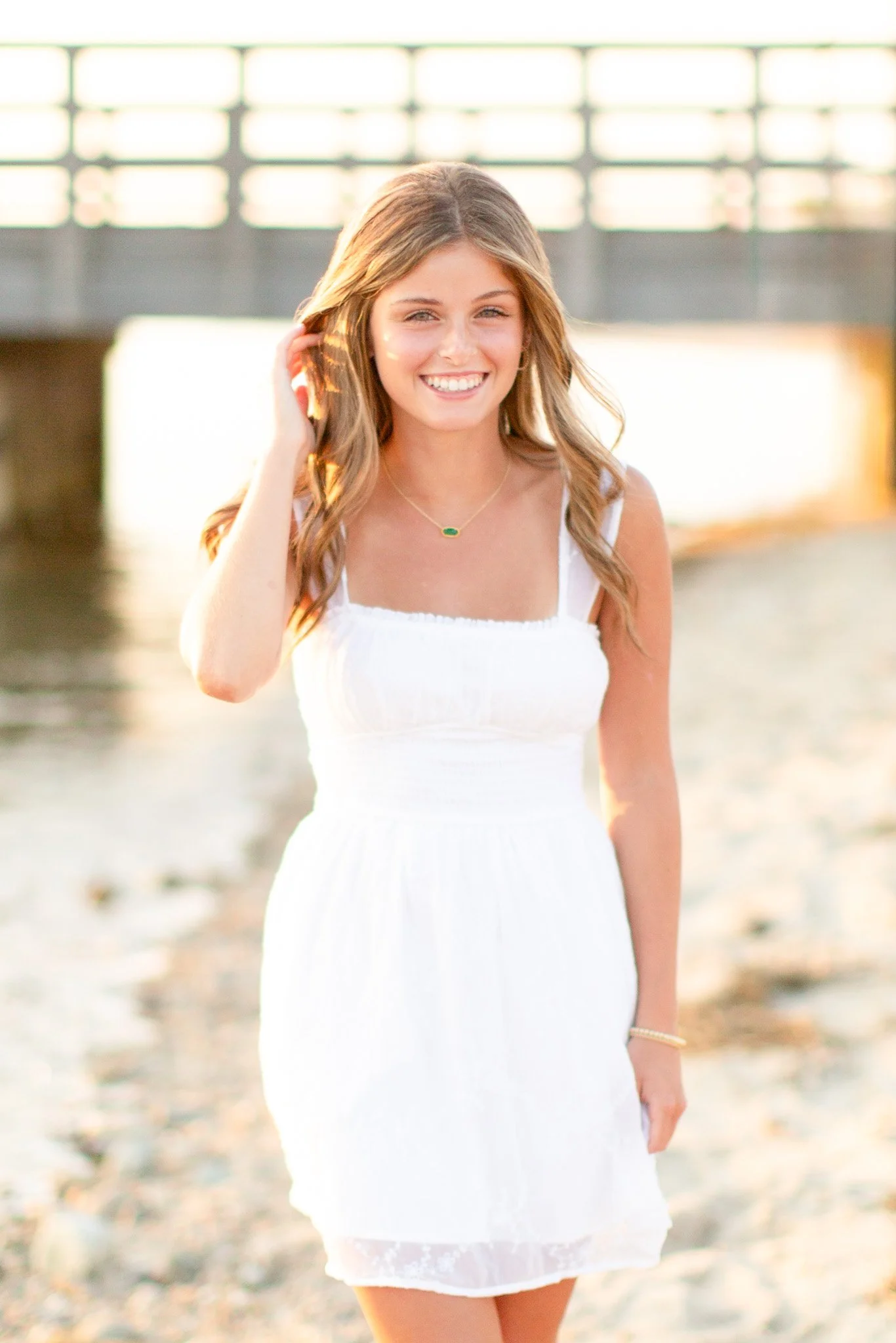 Class of 2025 senior portrait of Lily at Duxbury Beach in soft evening light