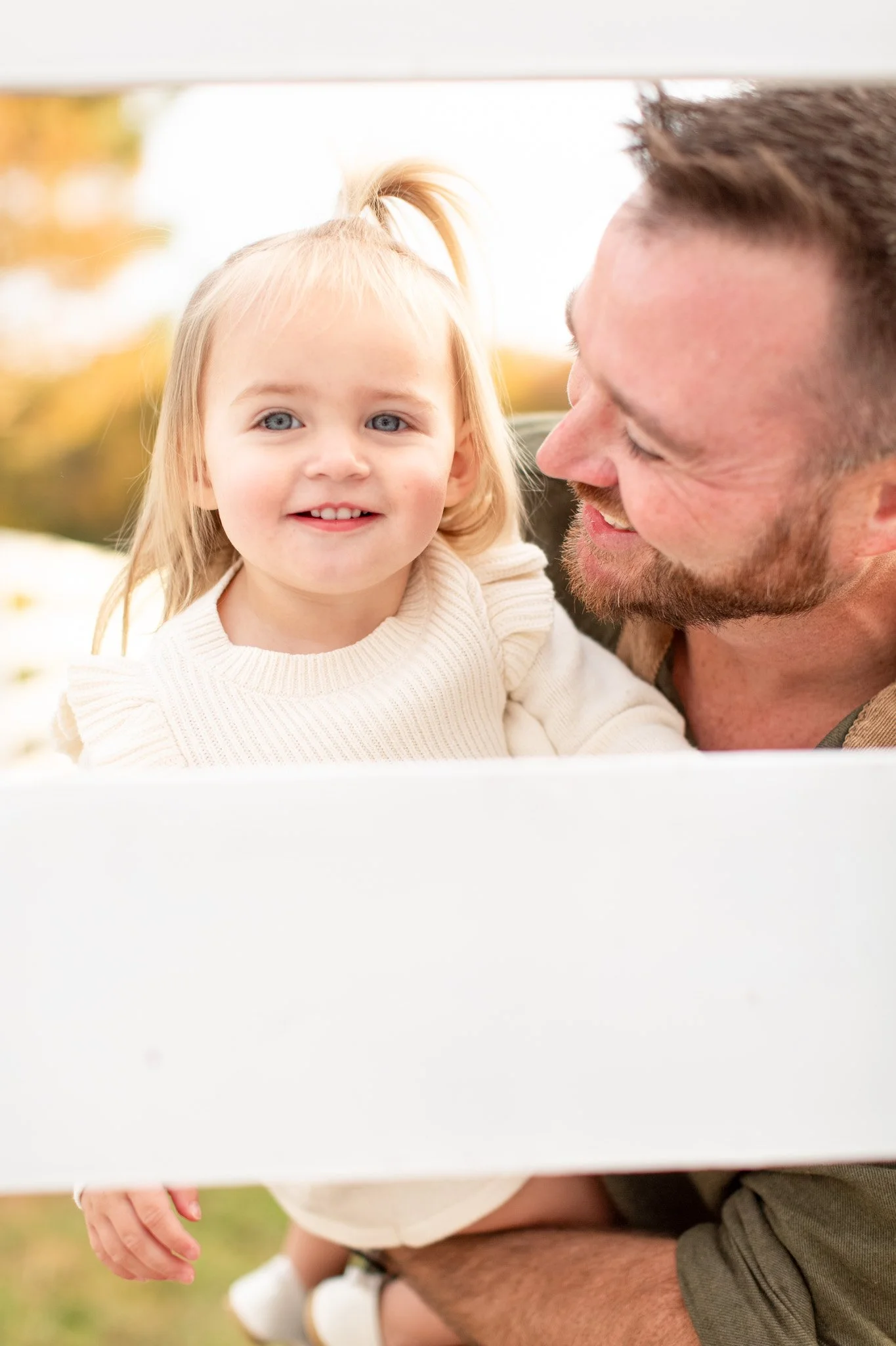 Dad interacting with daughter during a family session at Adams Farm
