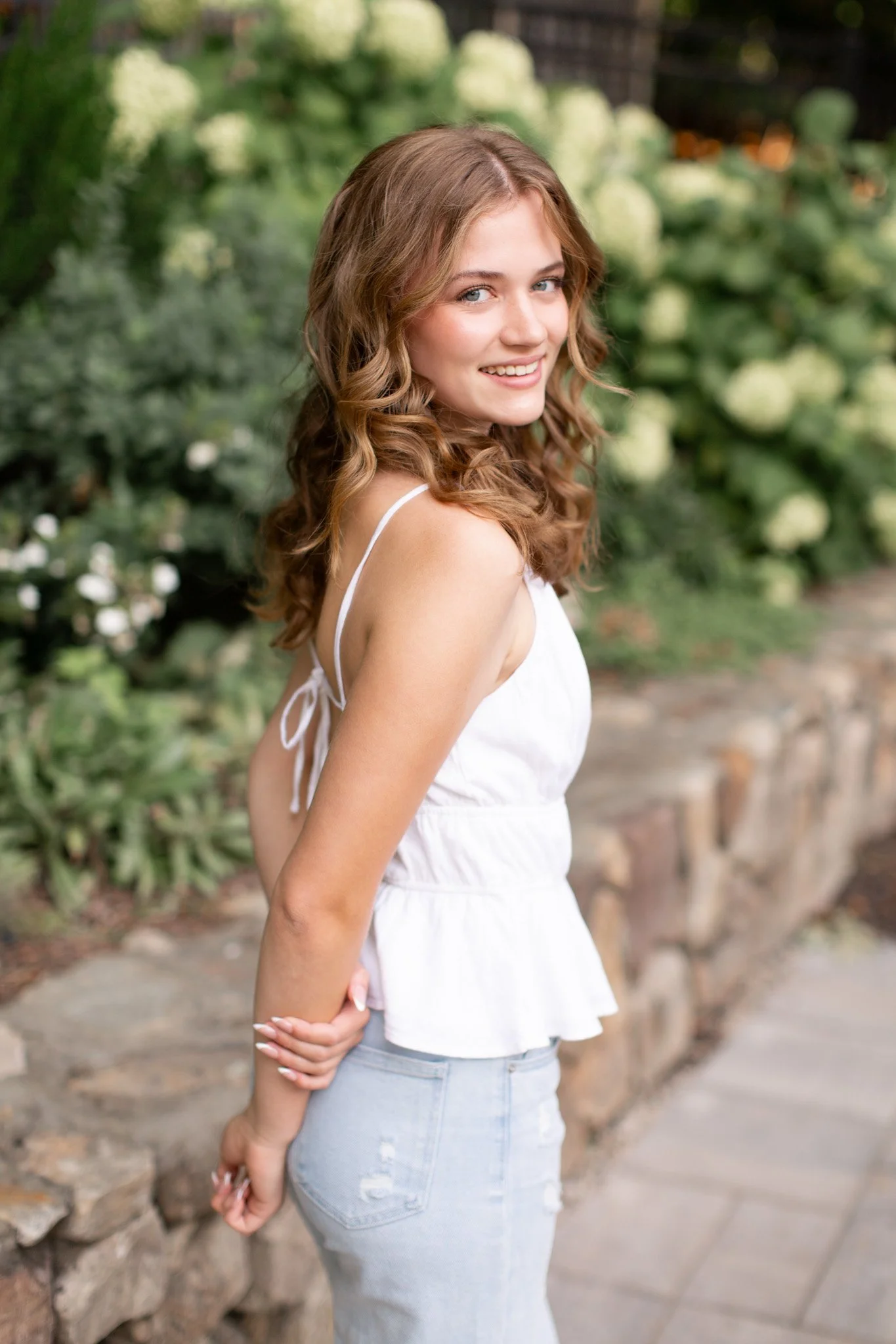 Senior portrait taken in a backyard setting by a Milton senior photographer