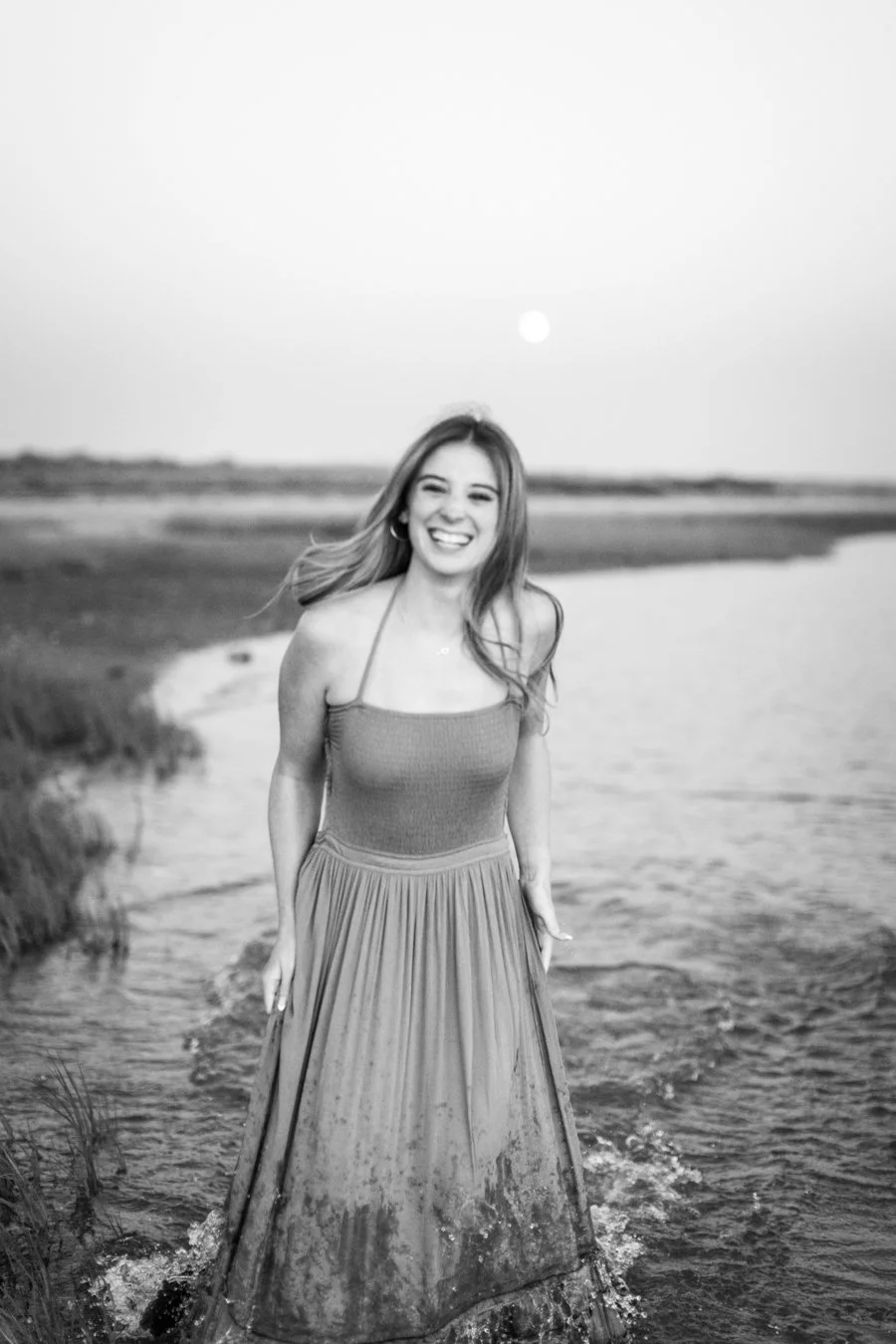 Senior session at Duxbury Beach with the moon rising over the Massachusetts coastline.