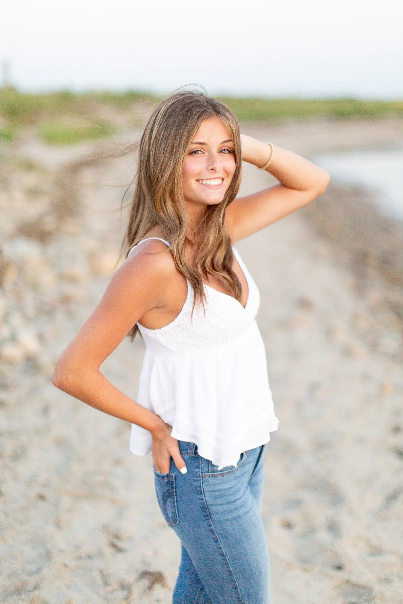 Senior photos at Duxbury Beach capturing movement and effortless confidence