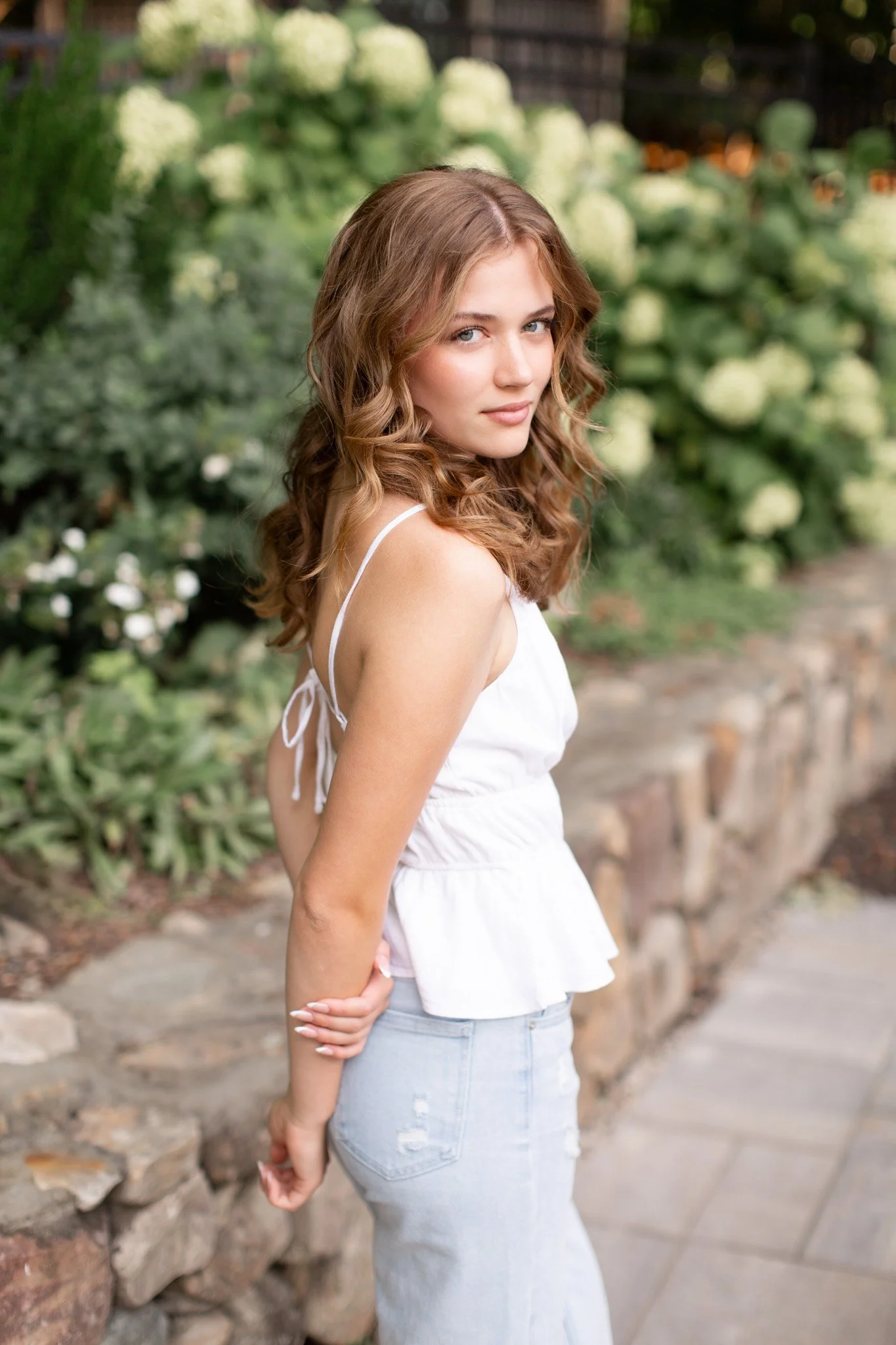 Senior girl posing confidently at Milton home during a Massachusetts senior photo session