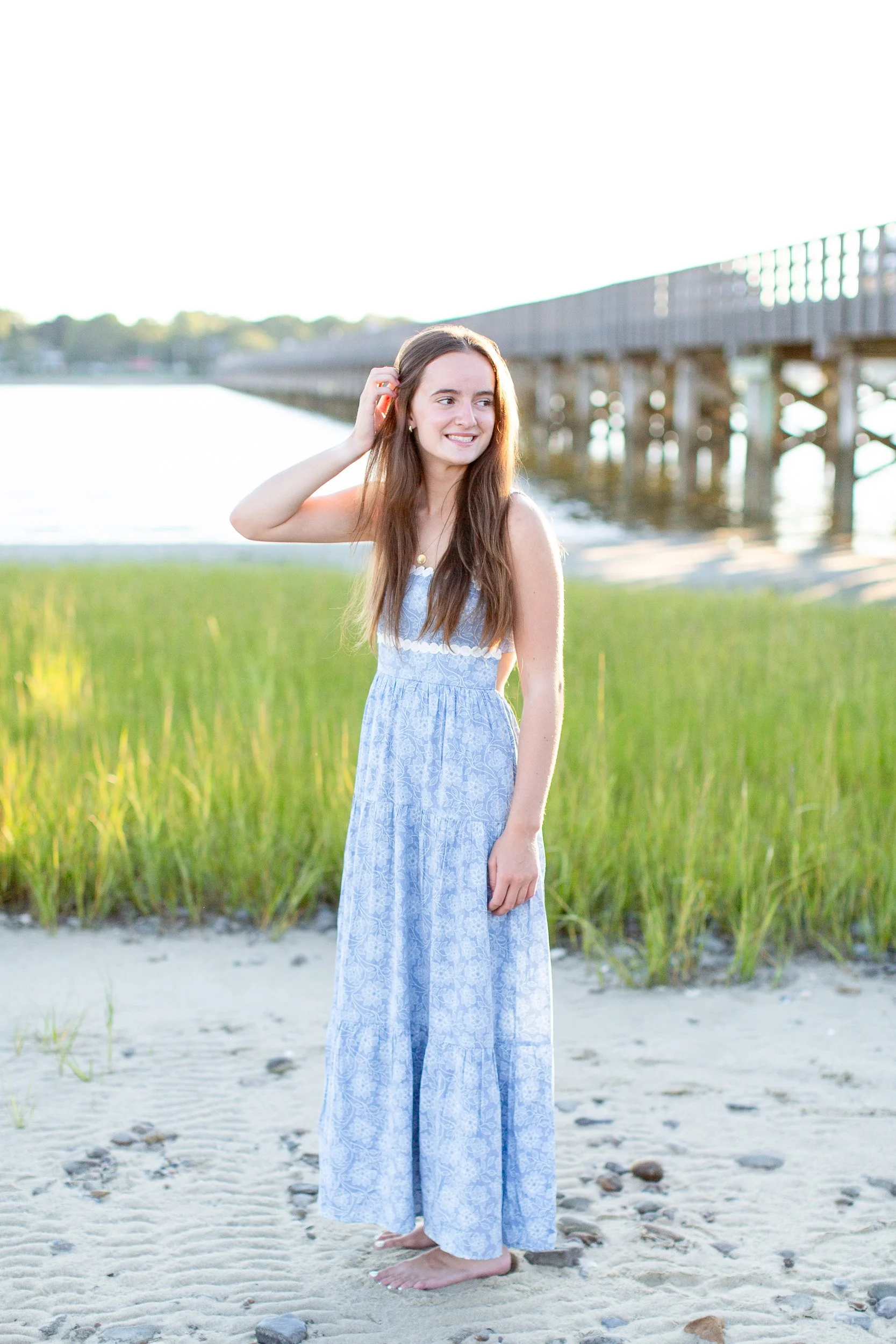 Senior portrait in a blue dress near the Duxbury Beach bridge
