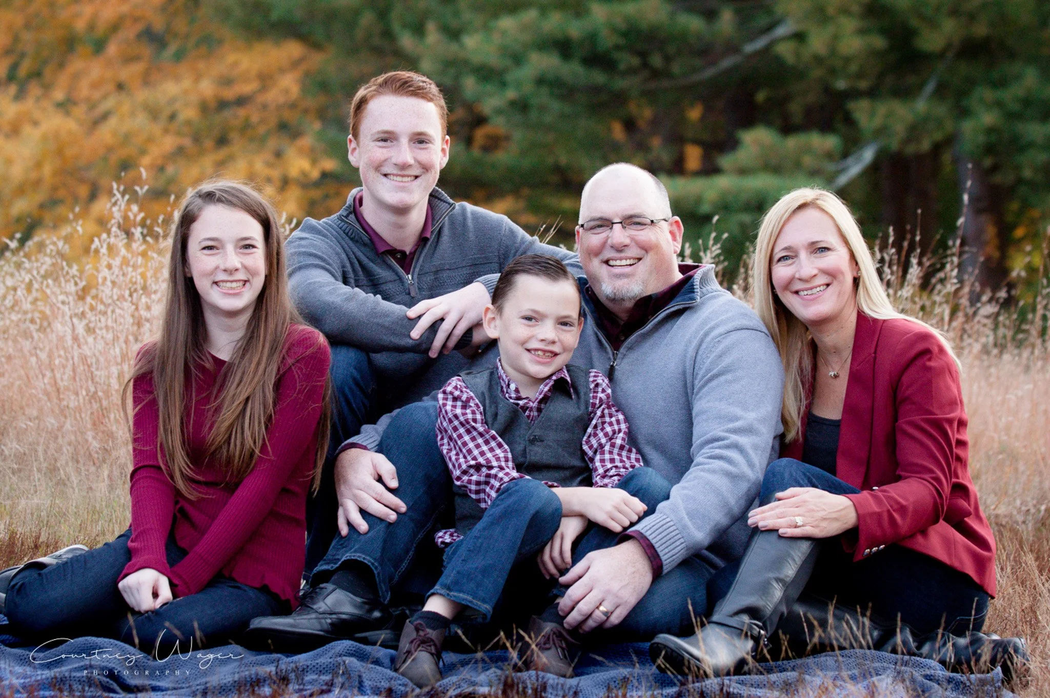 Parents smiling with their kids at Bird Park surrounded by autumn foliage