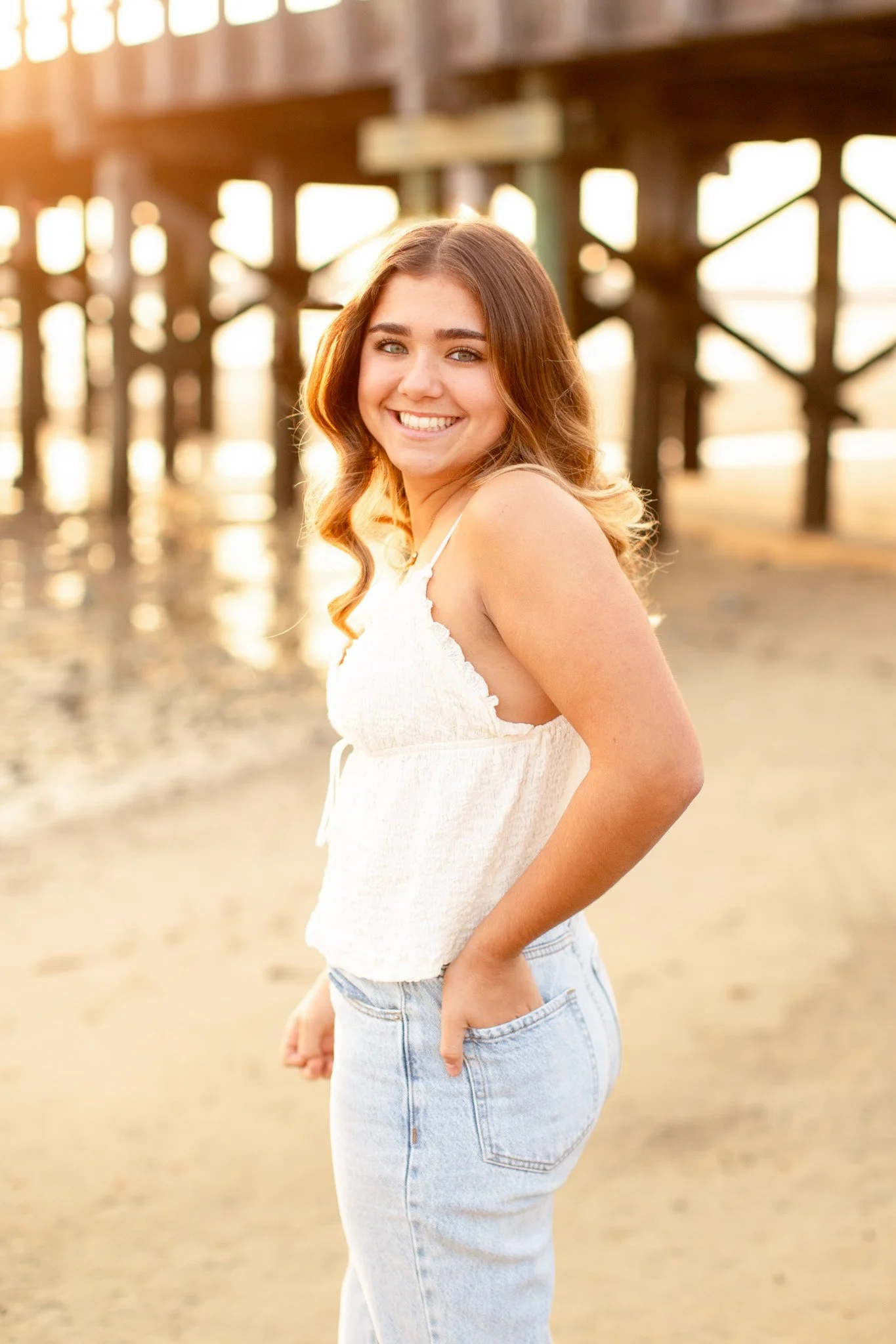 Senior photo of Mansfield MA senior at Duxbury Beach bridge with soft natural light
