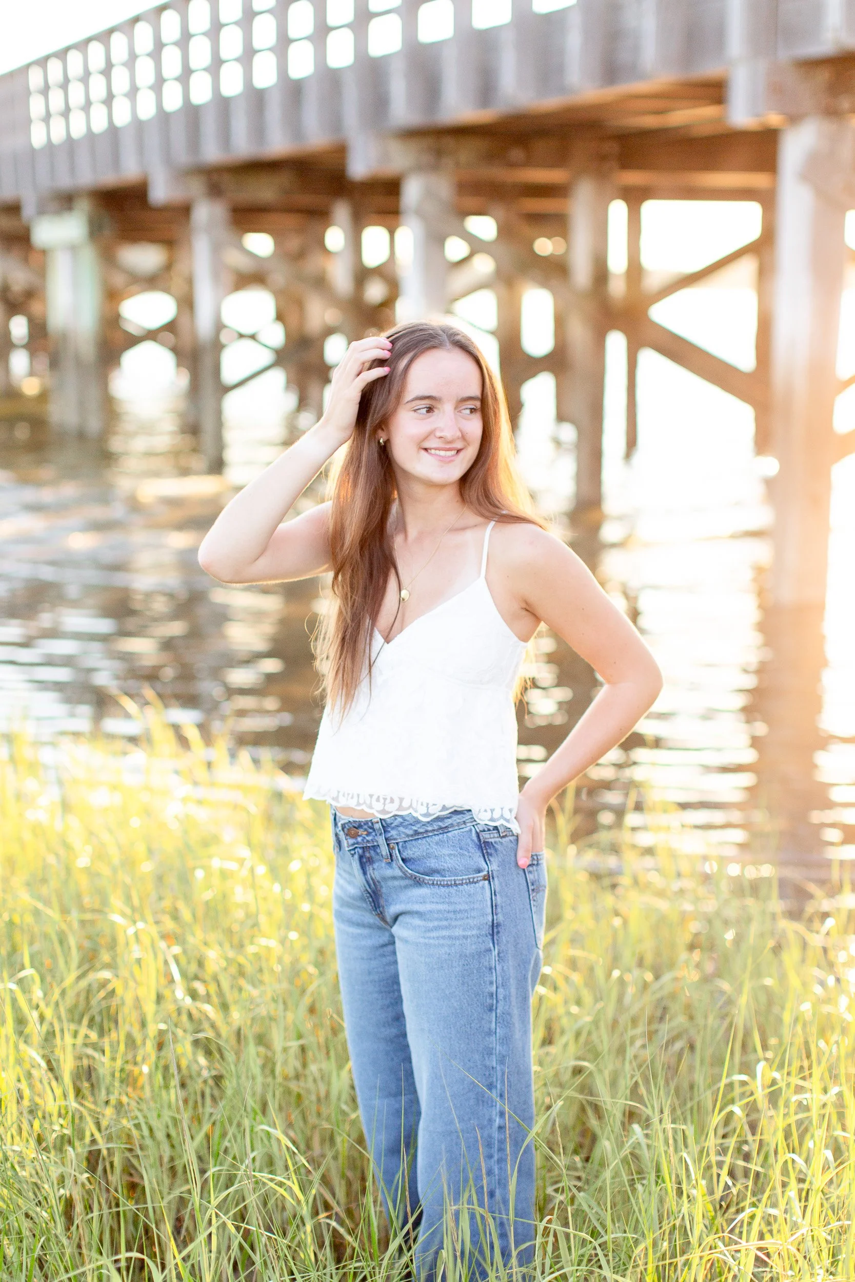Senior girl photographed along the wooden bridge in soft summer evening light