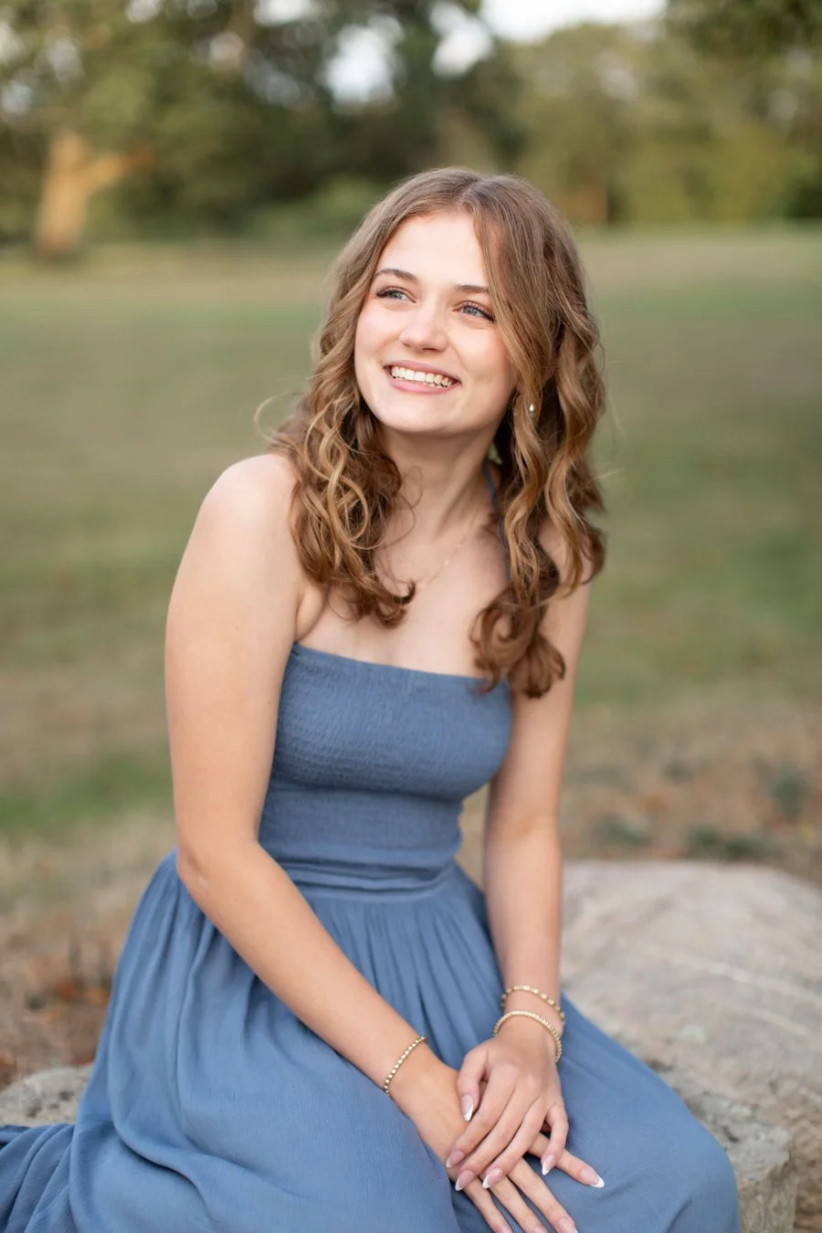 High school senior smiling naturally at her Dad during a senior photoshoot in Milton, Massachusetts