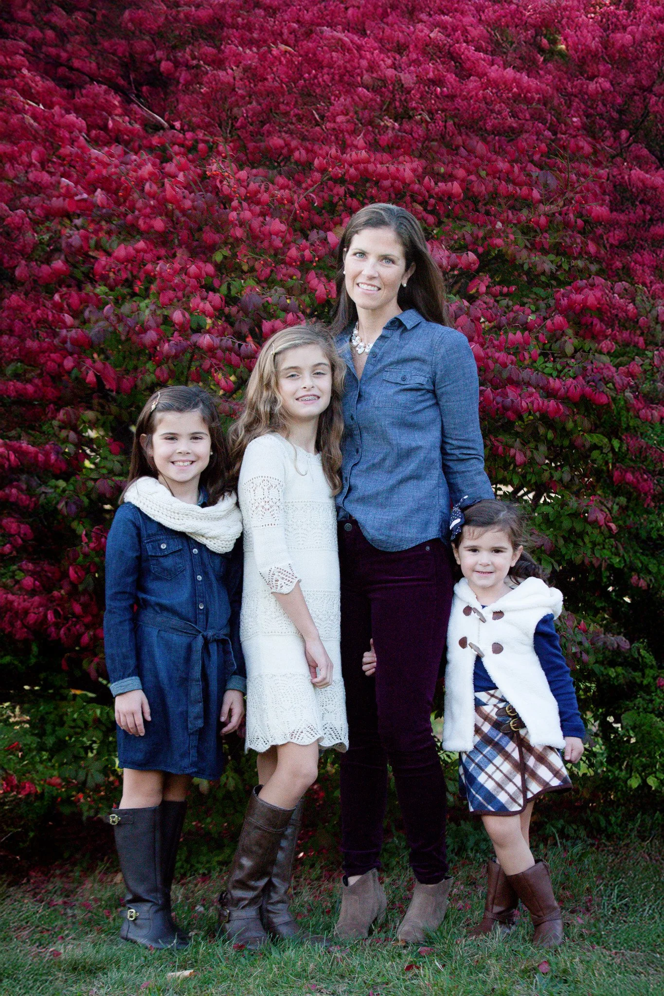 Mom and daughters sharing genuine smiles during a Walpole MA fall session
