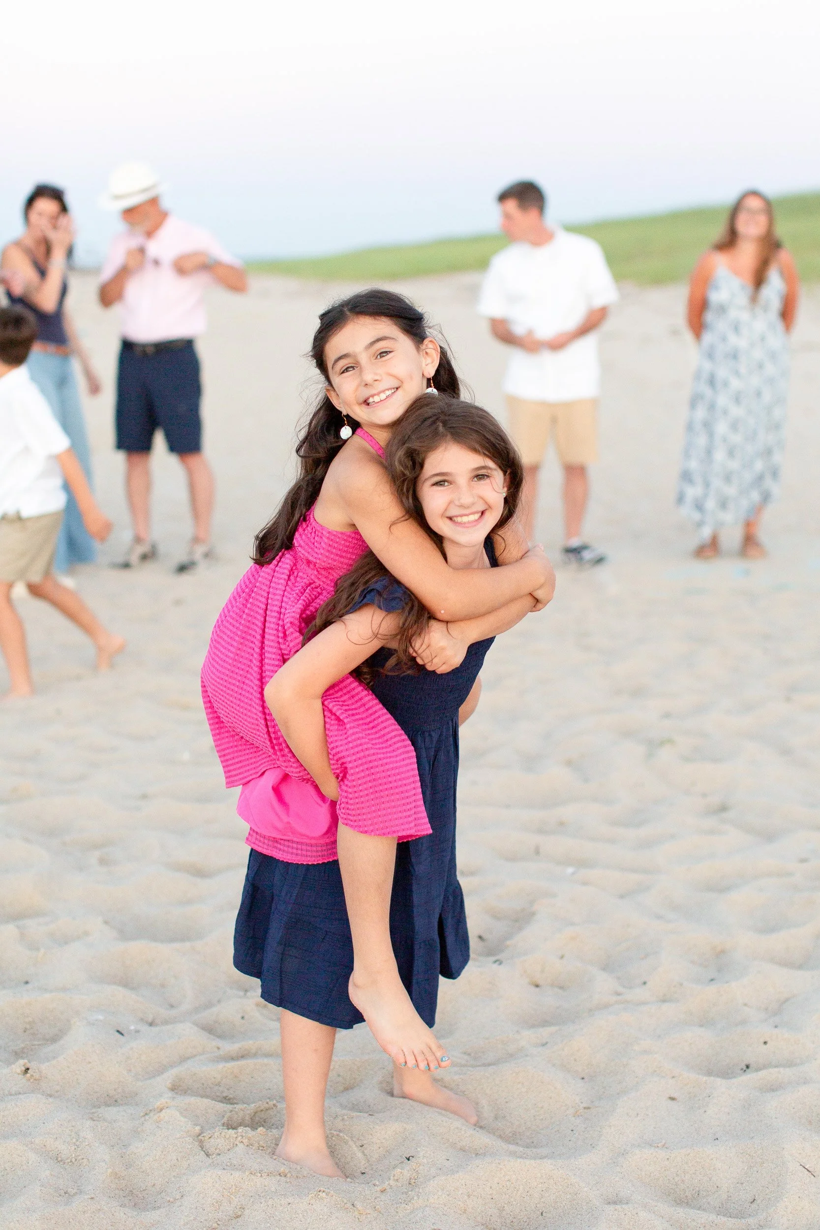 Cousins laughing together during their Cape Cod family photo session.