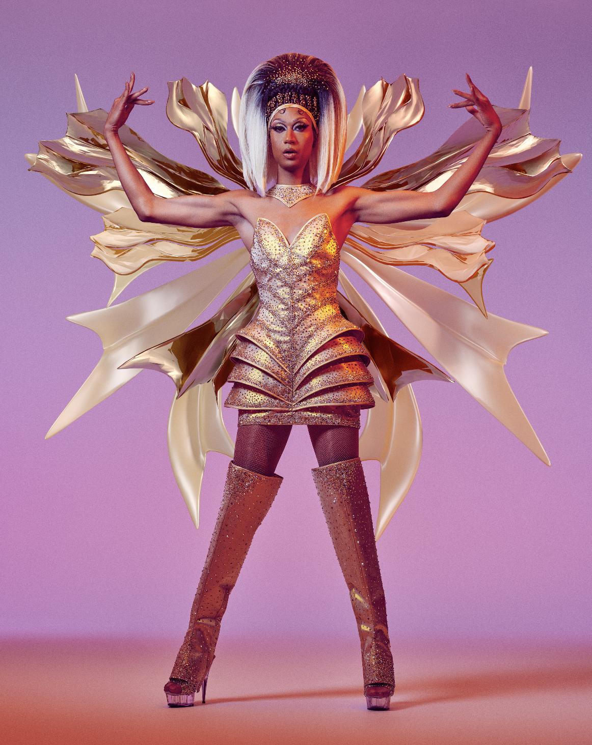 A person dressed in an elaborate gold costume with large, wing-like structures, posing with arms raised against a pastel purple background.