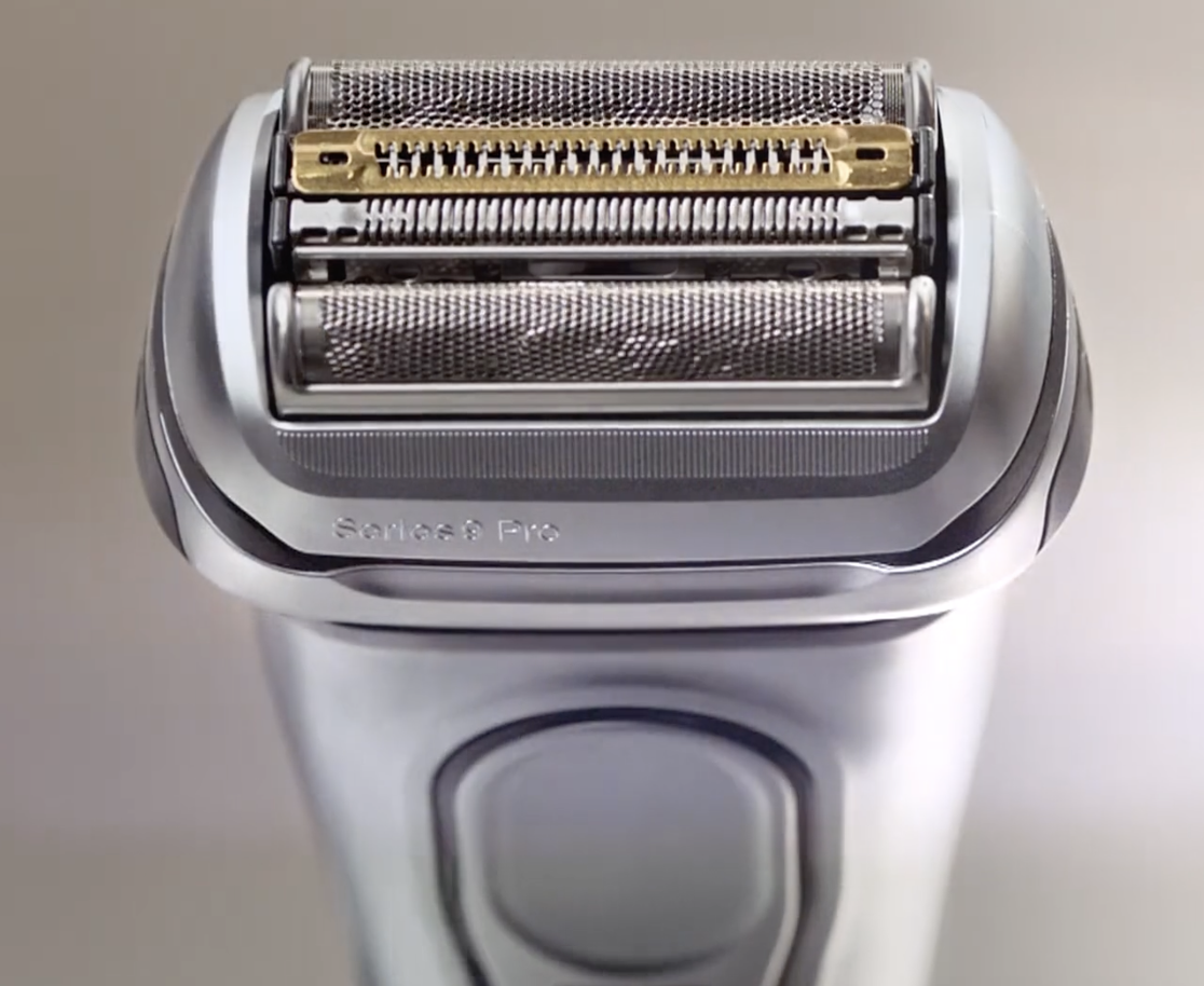 Close-up of an electric shaver with multiple foil cutters.