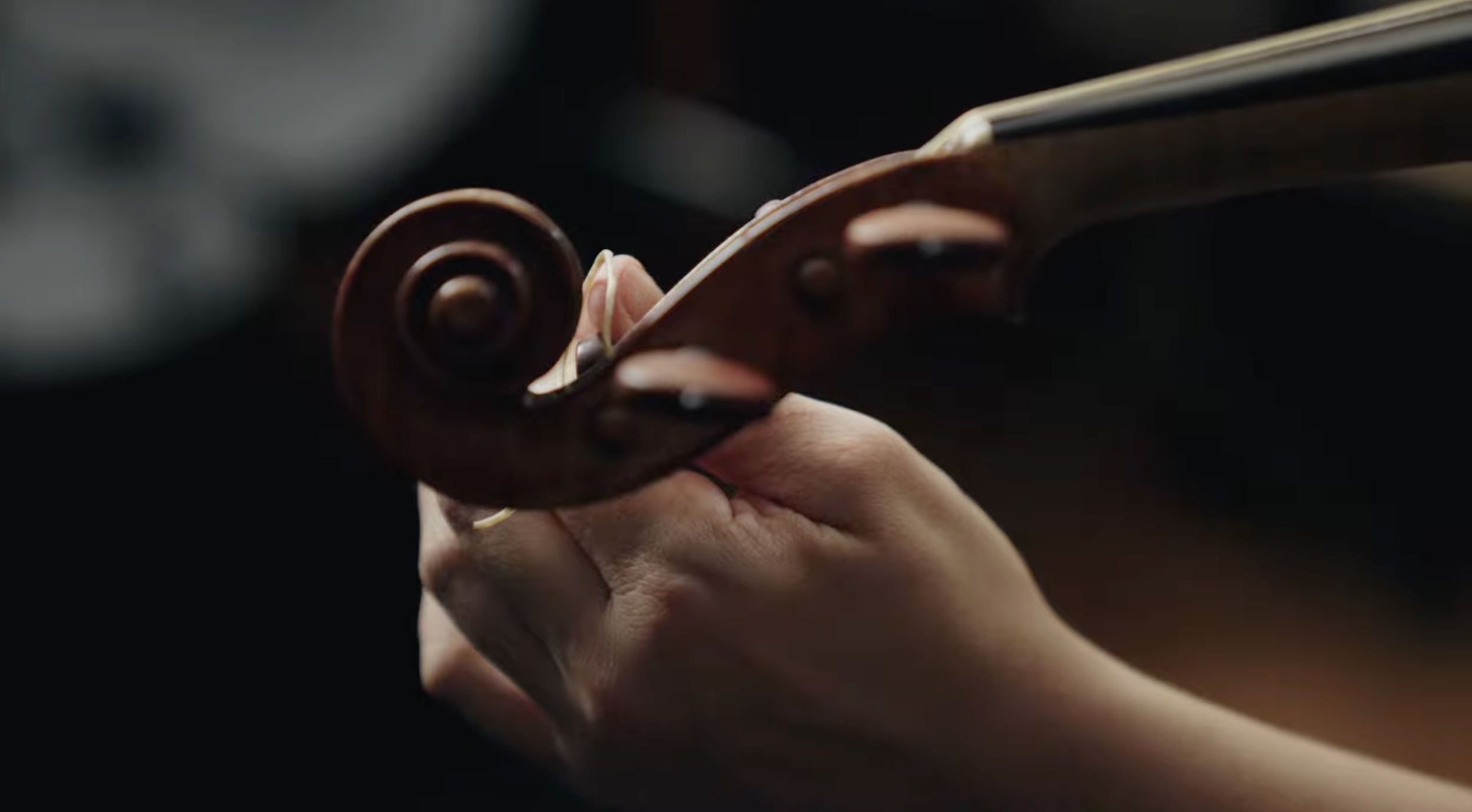 Violinist tuning a violin to A=415 for Historically Informed Performance (HIP)