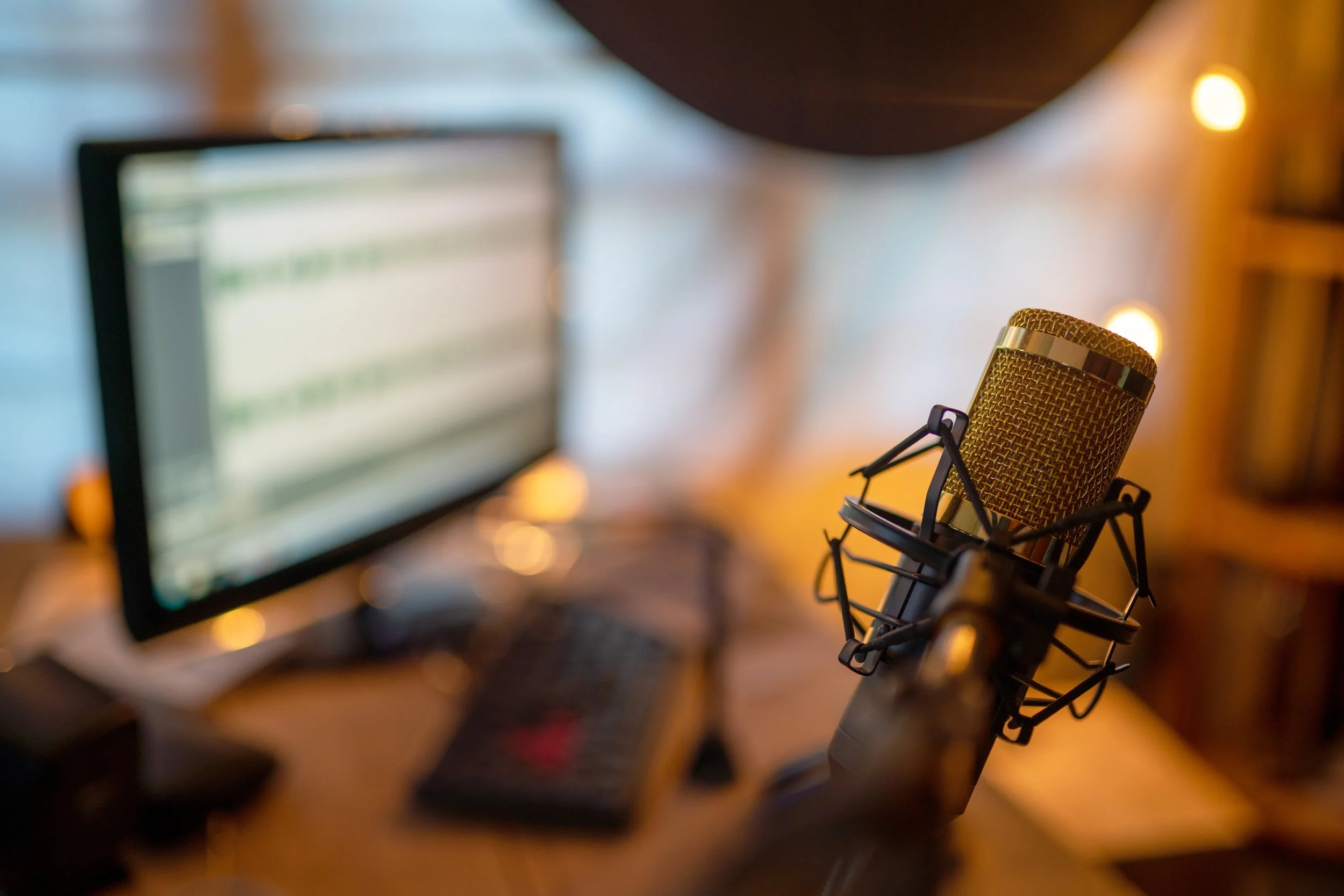 Home recording setup with microphone and computer for high-quality online violin teaching.