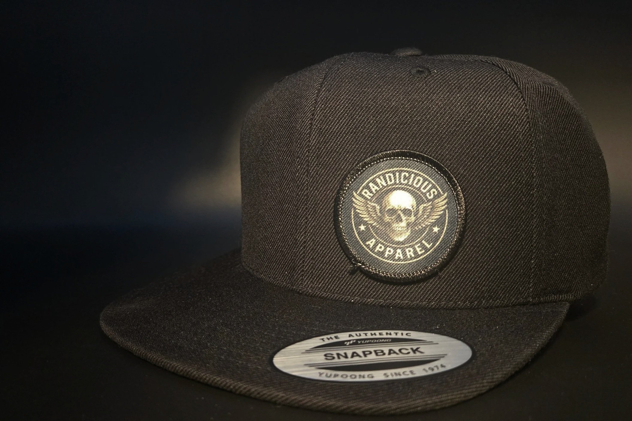 Black Randicious skull snapback hat with stitched patch on structured flat brim cap